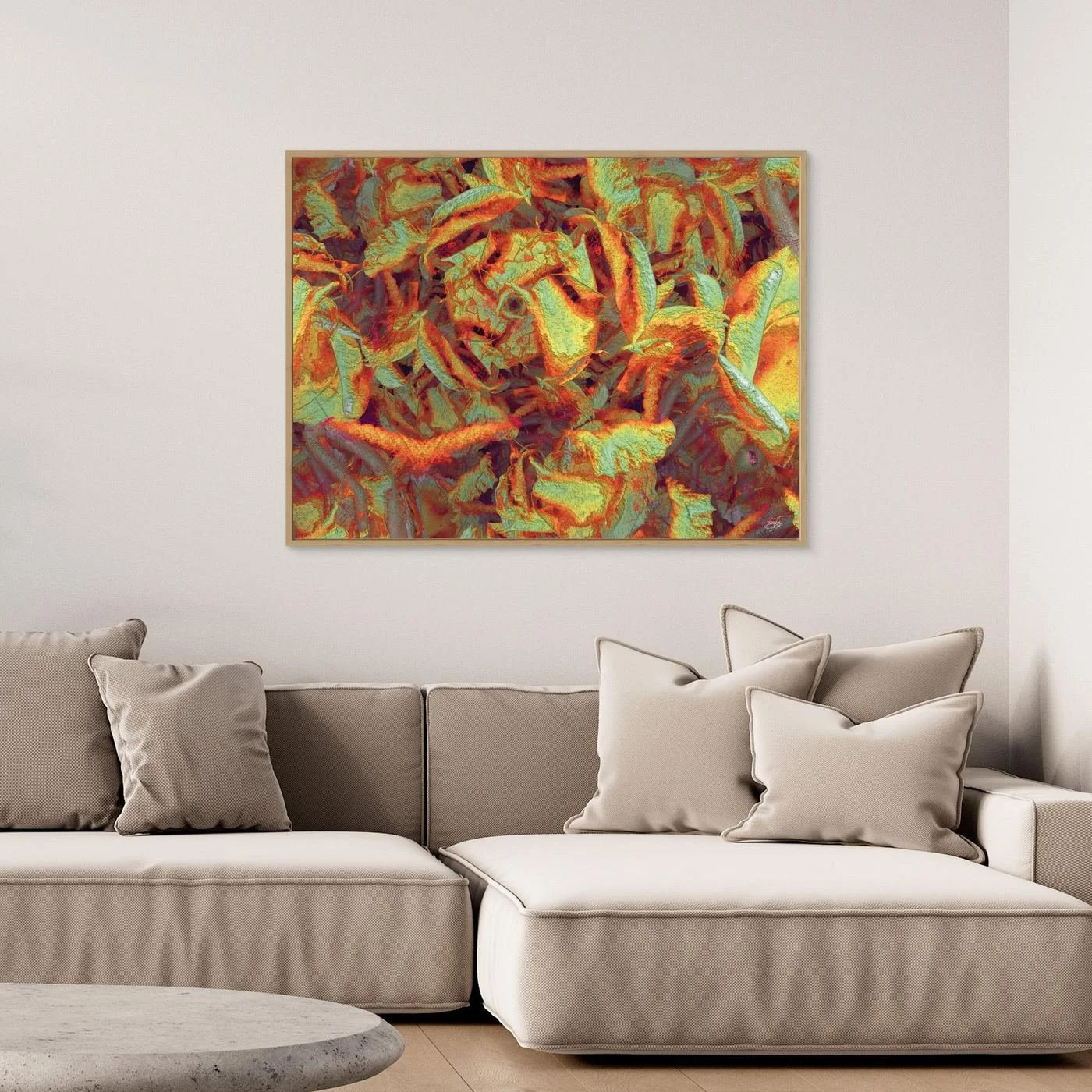 Abstract fine art print showcasing a dense, highly textured pattern of organic leaf-like shapes in warm autumn tones of orange, gold, and sage green, framed and ready to hang. Over grey sofa