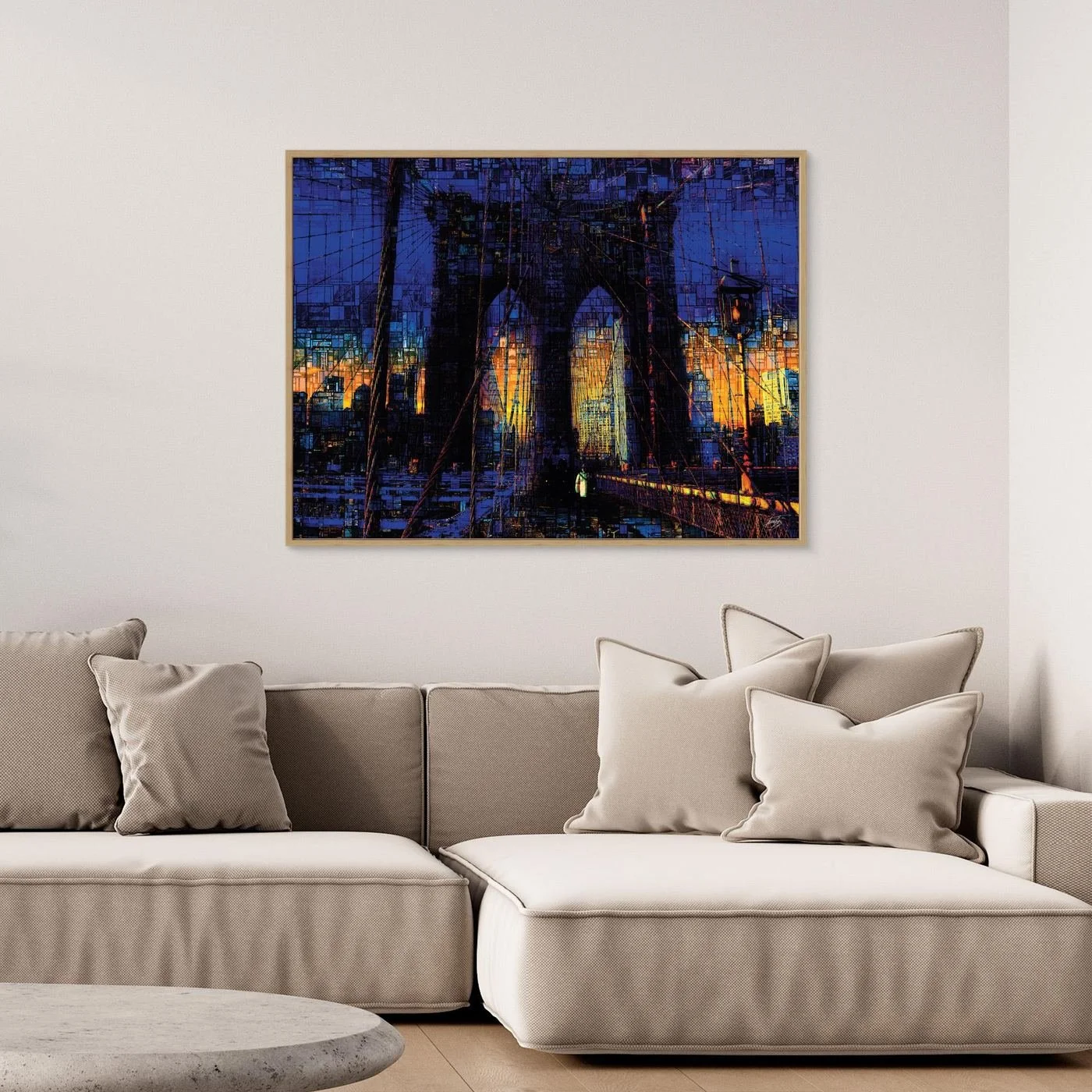 Abstract fine art print of the Brooklyn Bridge at sunset featuring a complex mosaic and pixelated texture in deep blue and vibrant golden tones, framed and ready to hang. Over grey couch
