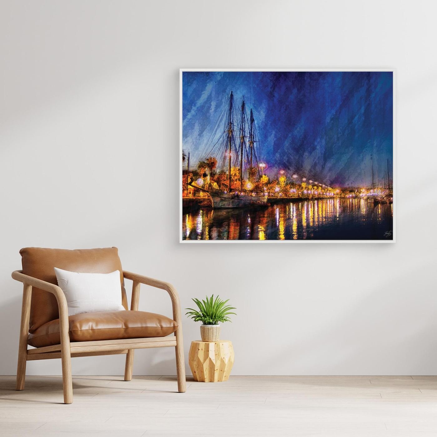Expressionist fine art of a night landscape of Port Vell in Barcelona, with a sailboat, palm trees, illuminated street lamps, and reflections on water, framed and ready to hang. With chair