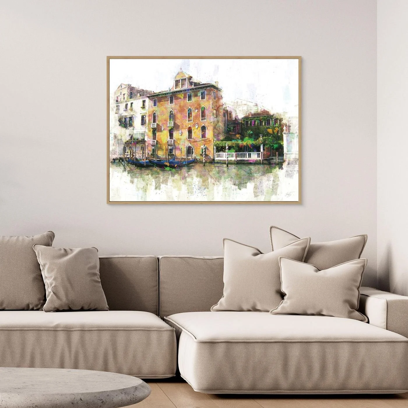 Vibrant fine art print of a classic Venice canal landscape with historic Italian architecture, docked gondolas, and colorful reflections on the water, framed and ready to hang. Over grey couch