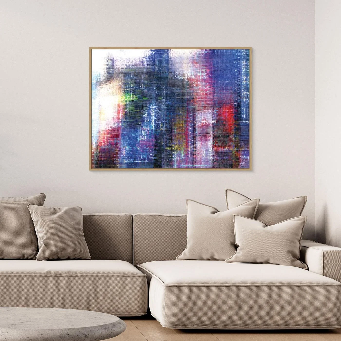 Abstract fine art print evoking a textured city skyline with vertical lines in deep blue, purple, and red tones, framed and ready to hang. Over grey sofa