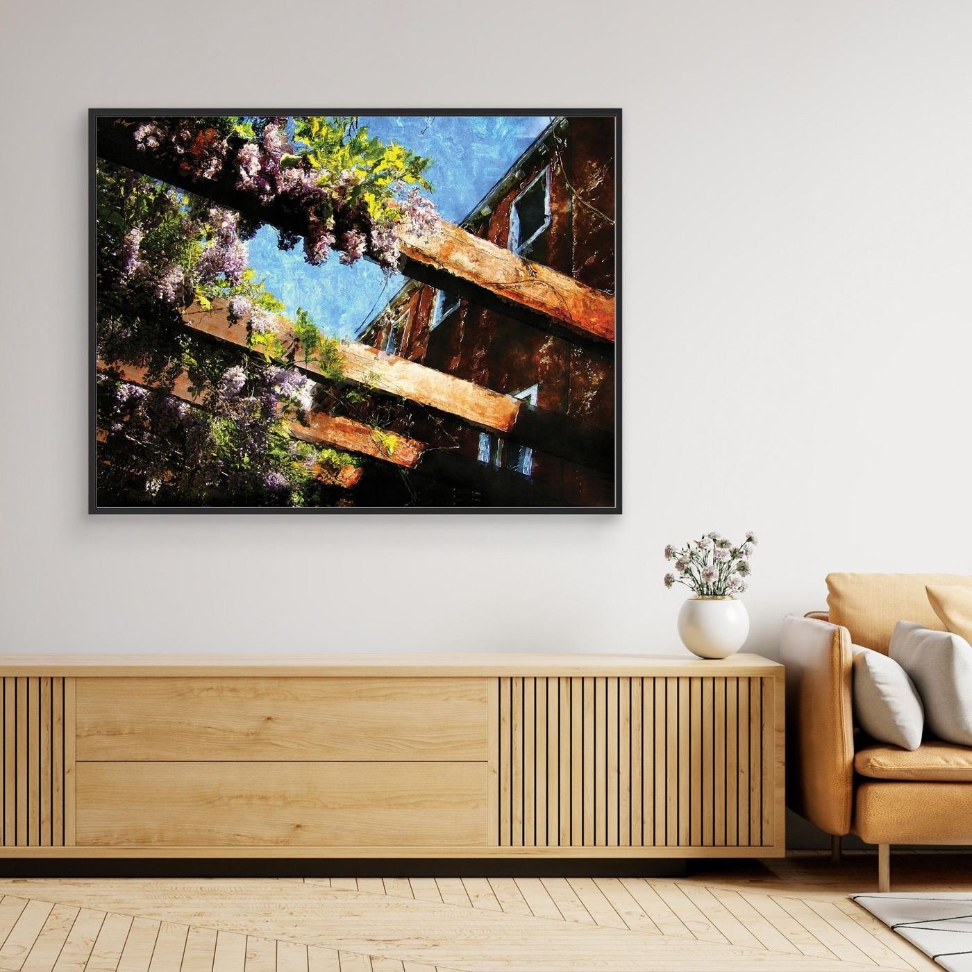 Impressionist fine art print showcasing purple wisteria flowers climbing over rustic wooden pergola beams against a textured blue sky, framed and ready to hang. Over wooden console