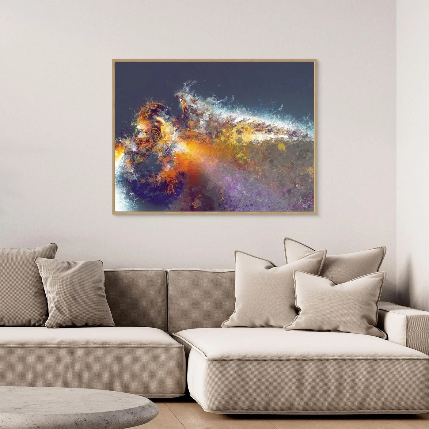 Dynamic abstract fine art print featuring explosive textured splatters in gold, orange, and white tones against a dark grey background, framed and ready to hang. Over grey couch