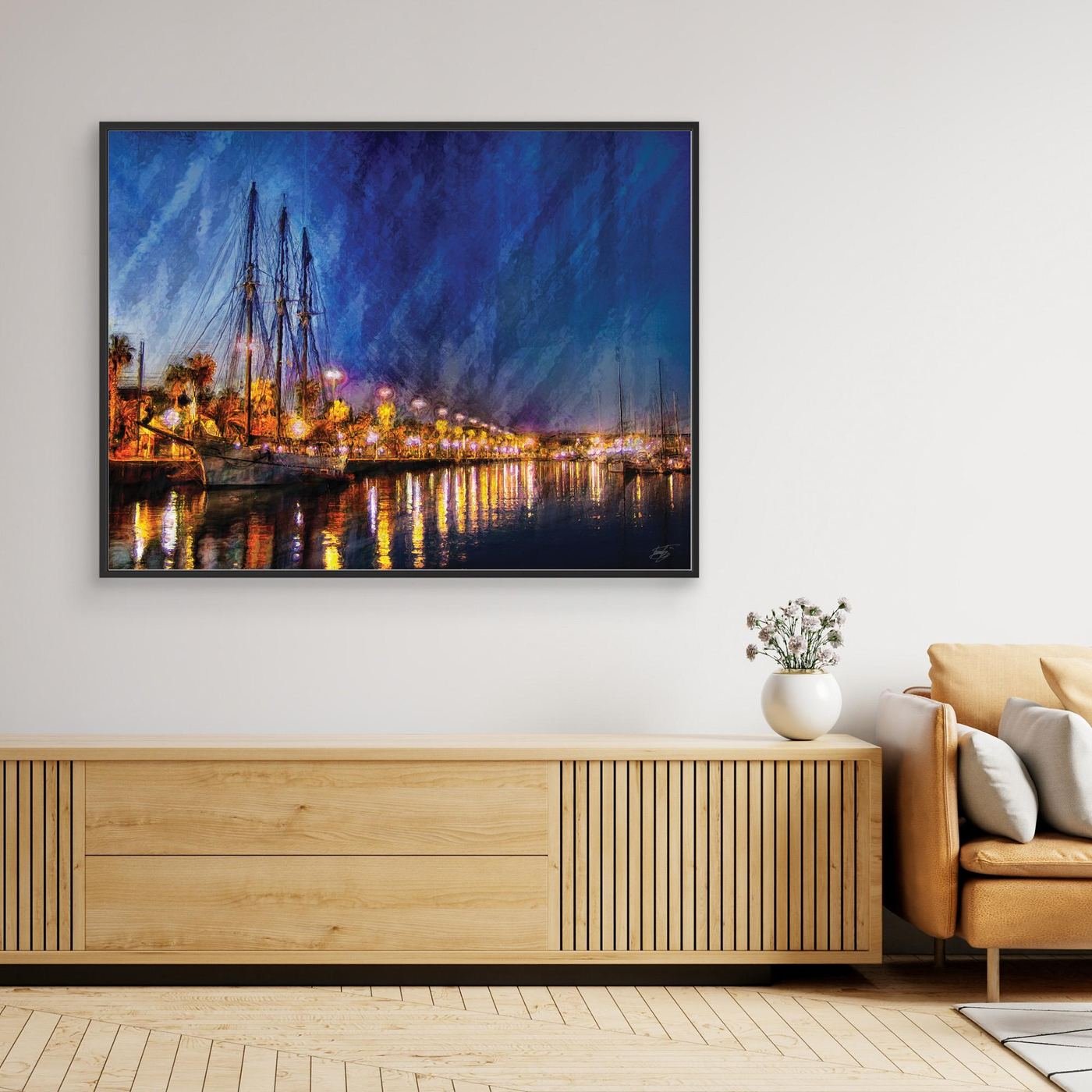 Expressionist fine art of a night landscape of Port Vell in Barcelona, with a sailboat, palm trees, illuminated street lamps, and reflections on water, framed and ready to hang. Over wooden console