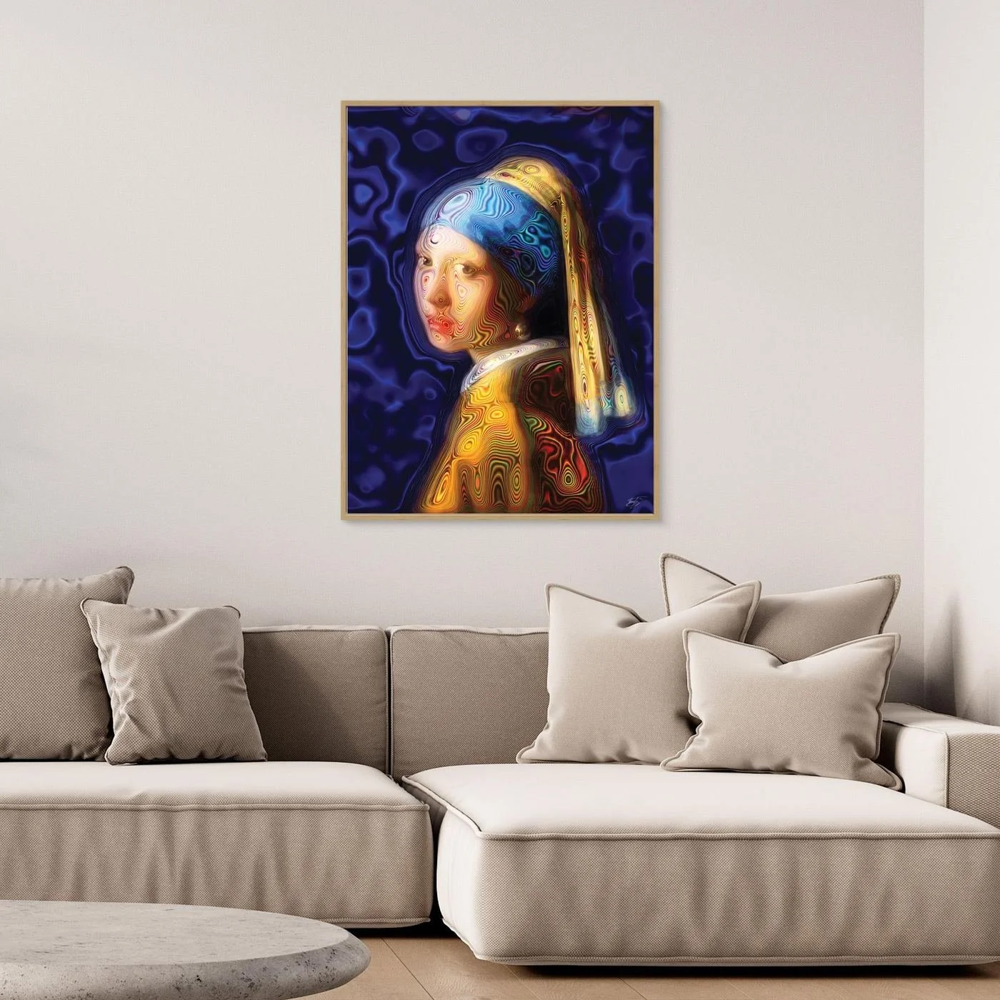 Contemporary fine art print of a psychedelic reinterpretation of Vermeer's Girl with a Pearl Earring, with vibrant blue and gold patterns, framed and ready to hang. Over grey couch