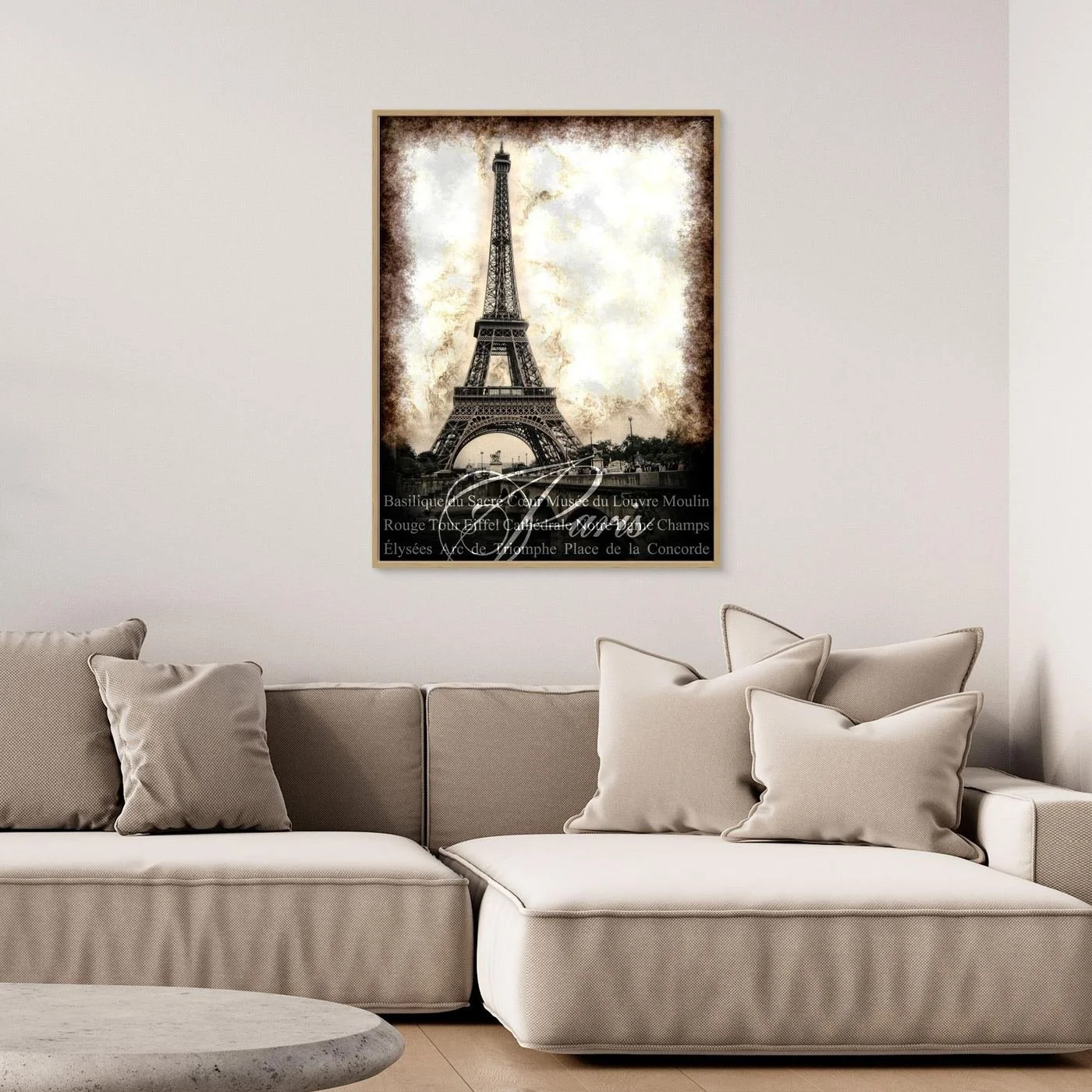 Vintage fine art print of Paris featuring the Eiffel Tower with a textured sepia background and elegant typography of French landmarks, framed and ready to hang. Over grey couch
