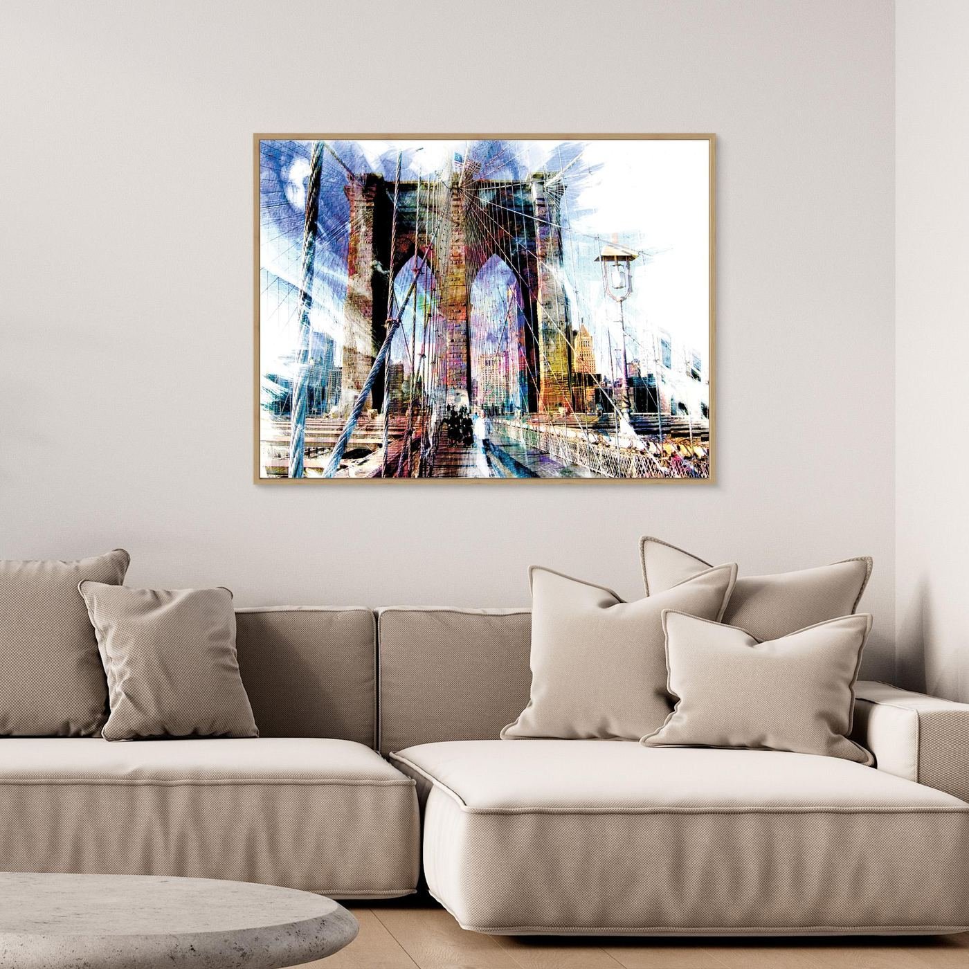 Expressionist fine art print of a dramatic walking perspective of the Brooklyn Bridge with high-contrast architectural line textures and bright highlights, framed and ready to hang. Over grey couch