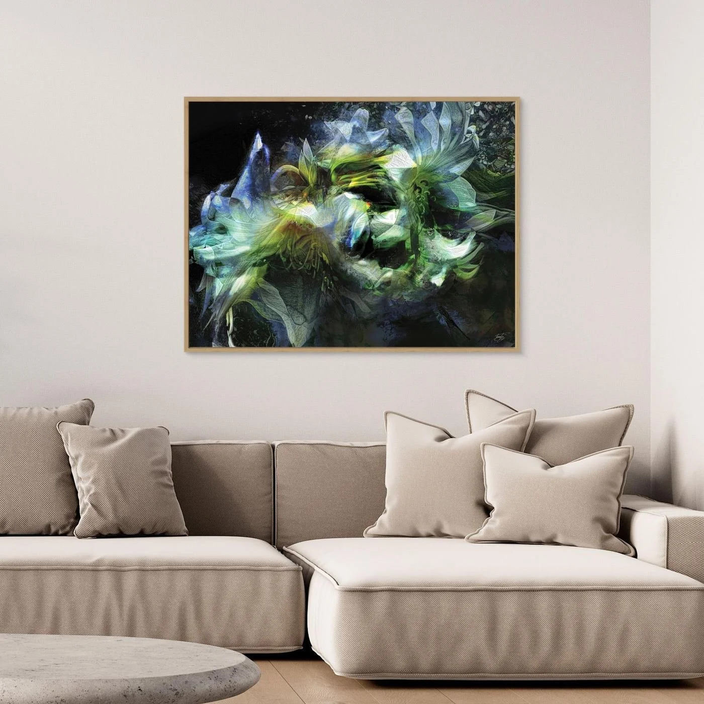 Abstract fine art print featuring ethereal lily flowers with intricate layered textures in green, teal, and blue tones against a dark background, framed and ready to hang. Over grey couch