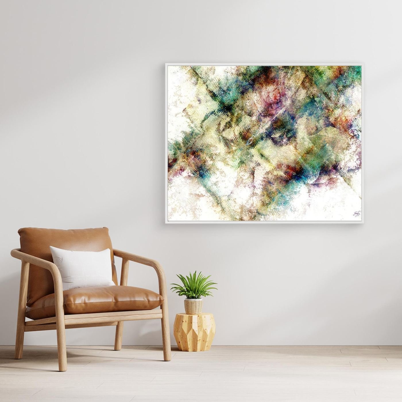 Abstract fine art print with heavy distressed textures and geometric overlays in green, gold, and burgundy tones on a bright background, framed and ready to hang. With chair