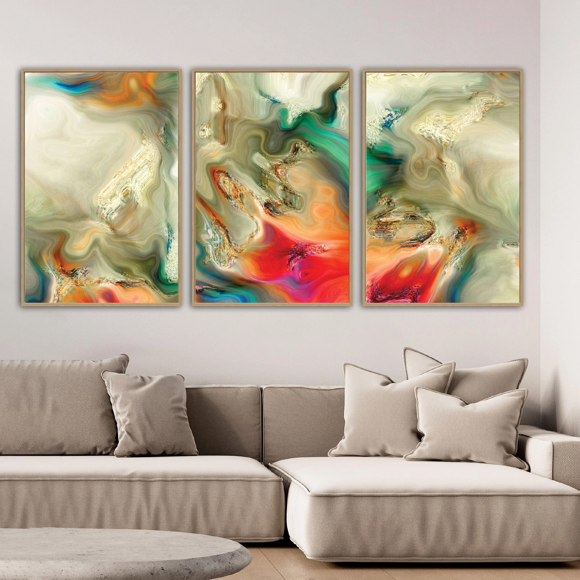 Abstract fine art triptych with liquid textures in earth tones, cream, and sage green, red and orange with metallic accents, framed and ready to hang. Over grey couch