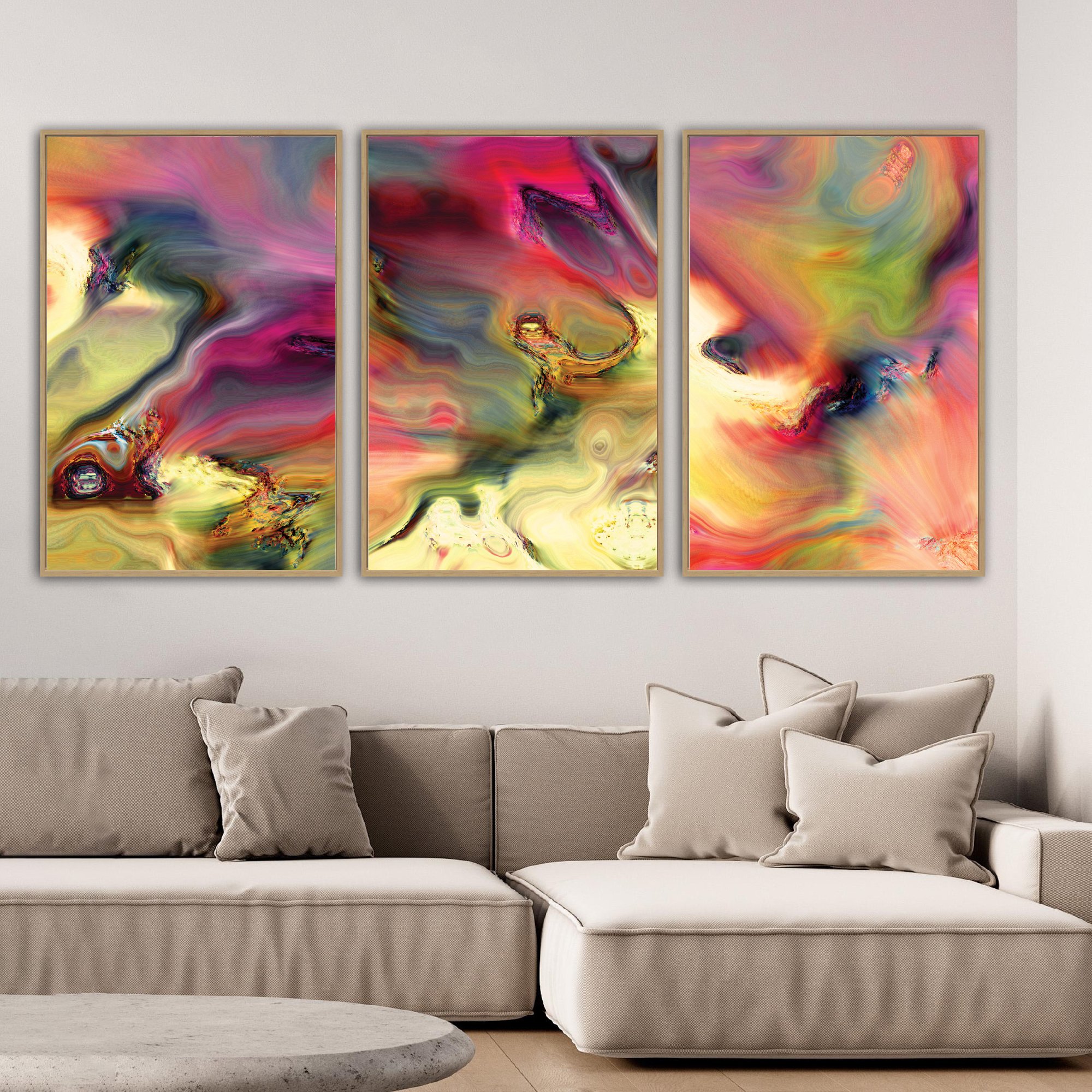 Abstract fine art triptych with swirling psychedelic liquid marble textures in vibrant magenta, ocher yellow, and wine red tones over a warm background, framed and ready to hang. Over grey couch