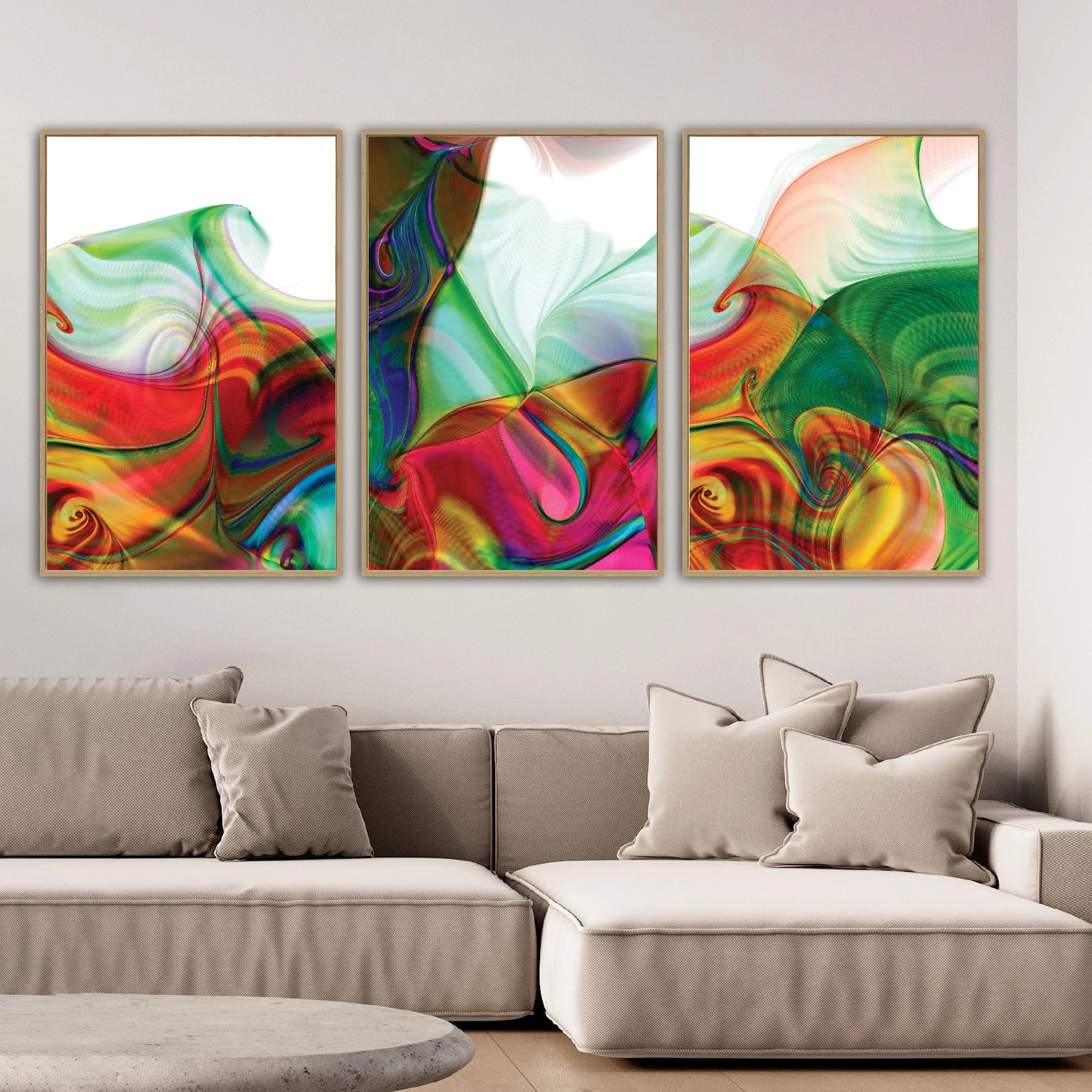 Abstract triptych with swirling fluid shapes and line patterns in vibrant crimson red, magenta, and emerald green over white background, framed and ready to hang. Over grey couch