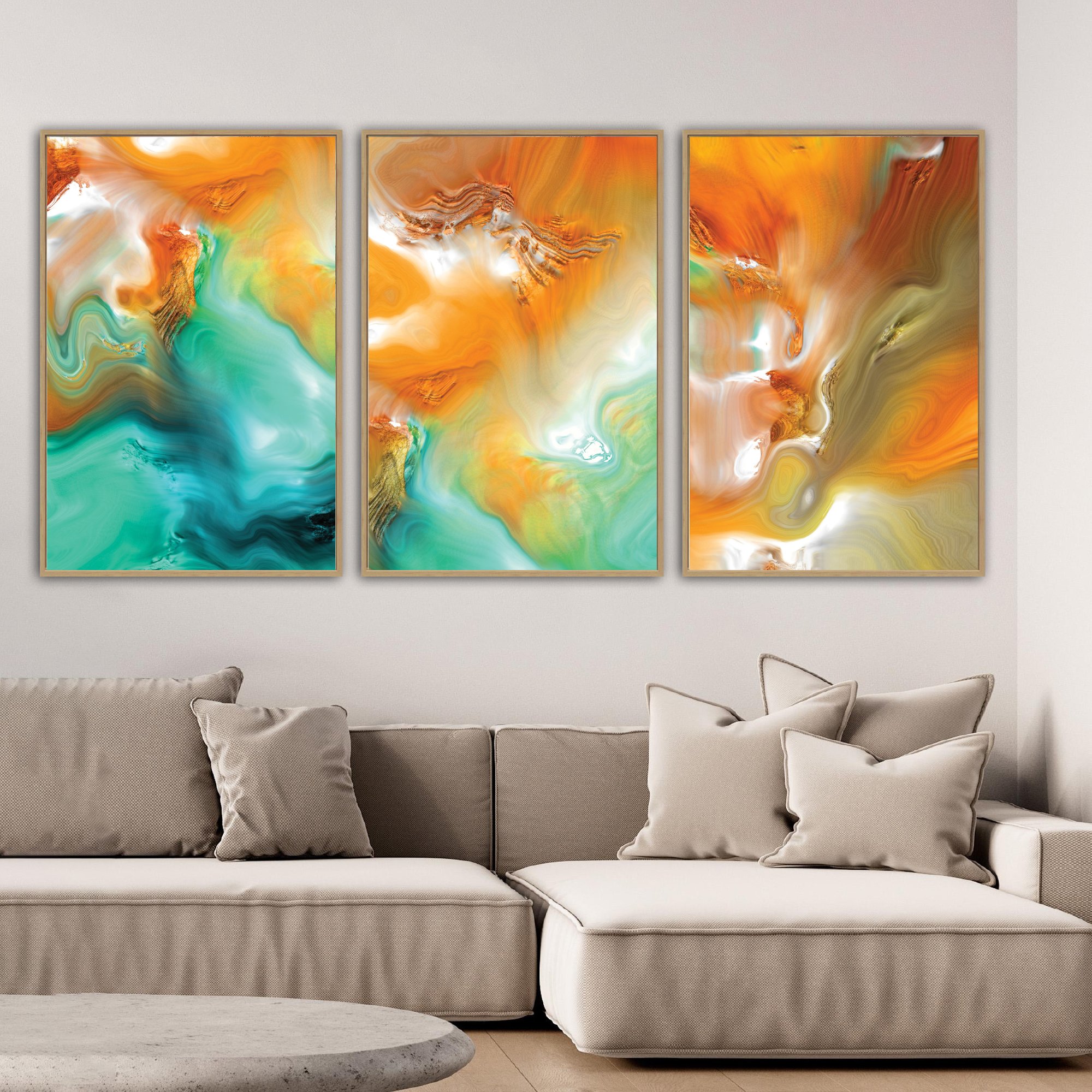 Abstract fine art triptych with flowing liquid marble textures in orange, ocher, and teal green tones, over a bright background, framed and ready to hang. Over grey couch