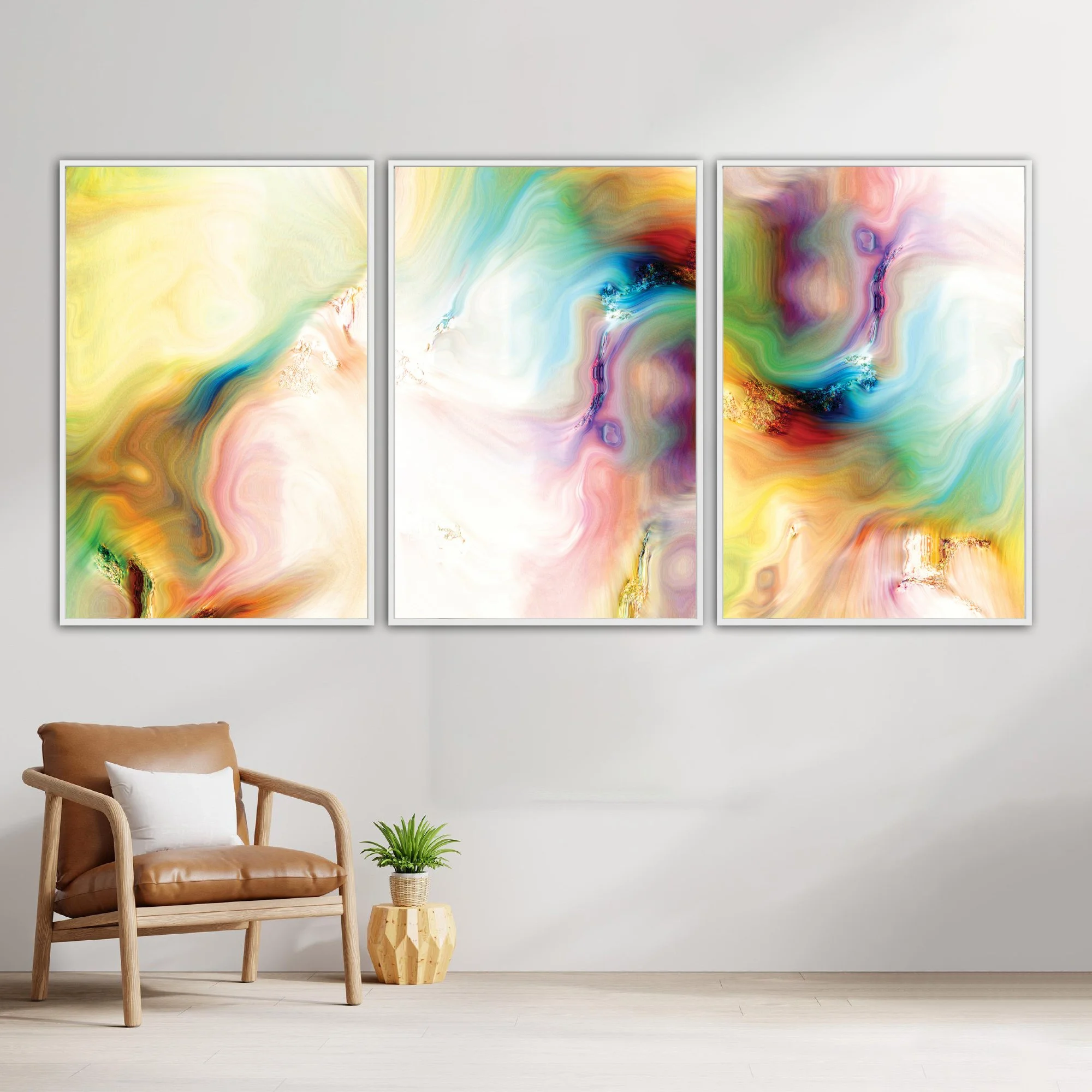 Abstract fine art triptych with textures and swirls in  yellow, green, turquoise, and pink with gold accents on a white background, framed and ready to hang. With chair