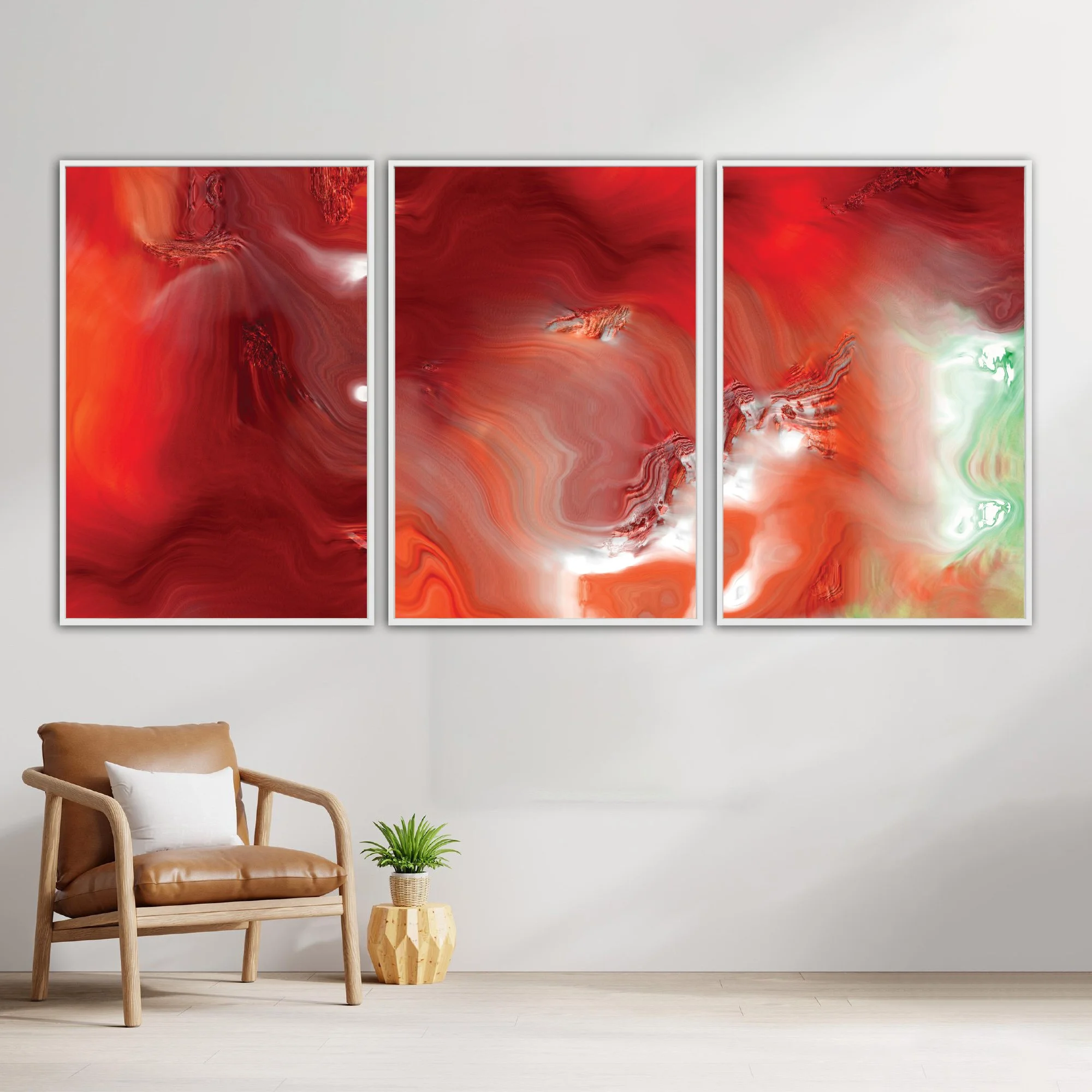 Abstract fine art triptych with dense, flowing liquid marble textures in vibrant crimson red, burgundy, and coral orange, white highlights and light green, framed and ready to hang. With chair