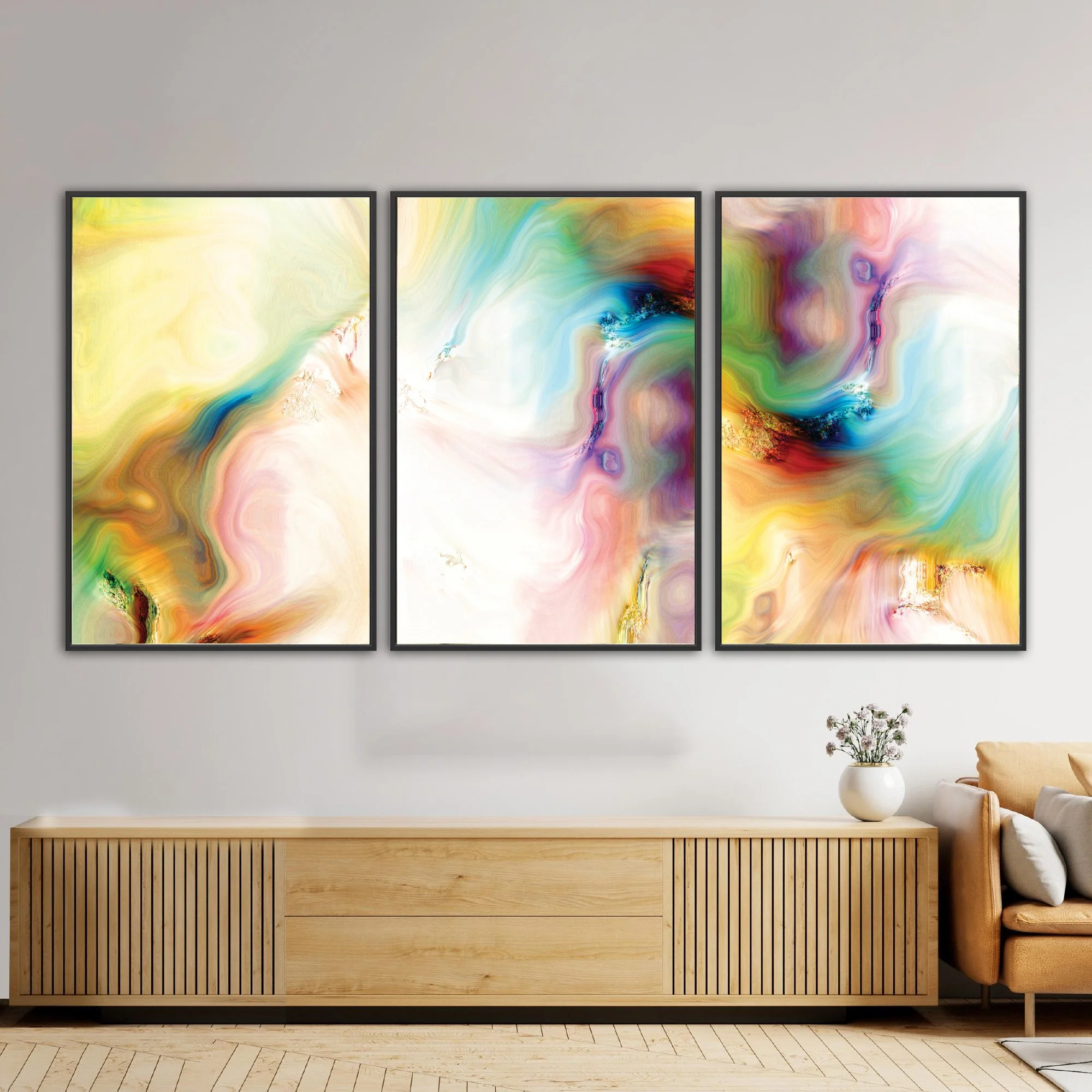 Abstract fine art triptych with textures and swirls in  yellow, green, turquoise, and pink with gold accents on a white background, framed and ready to hang. Over wooden console