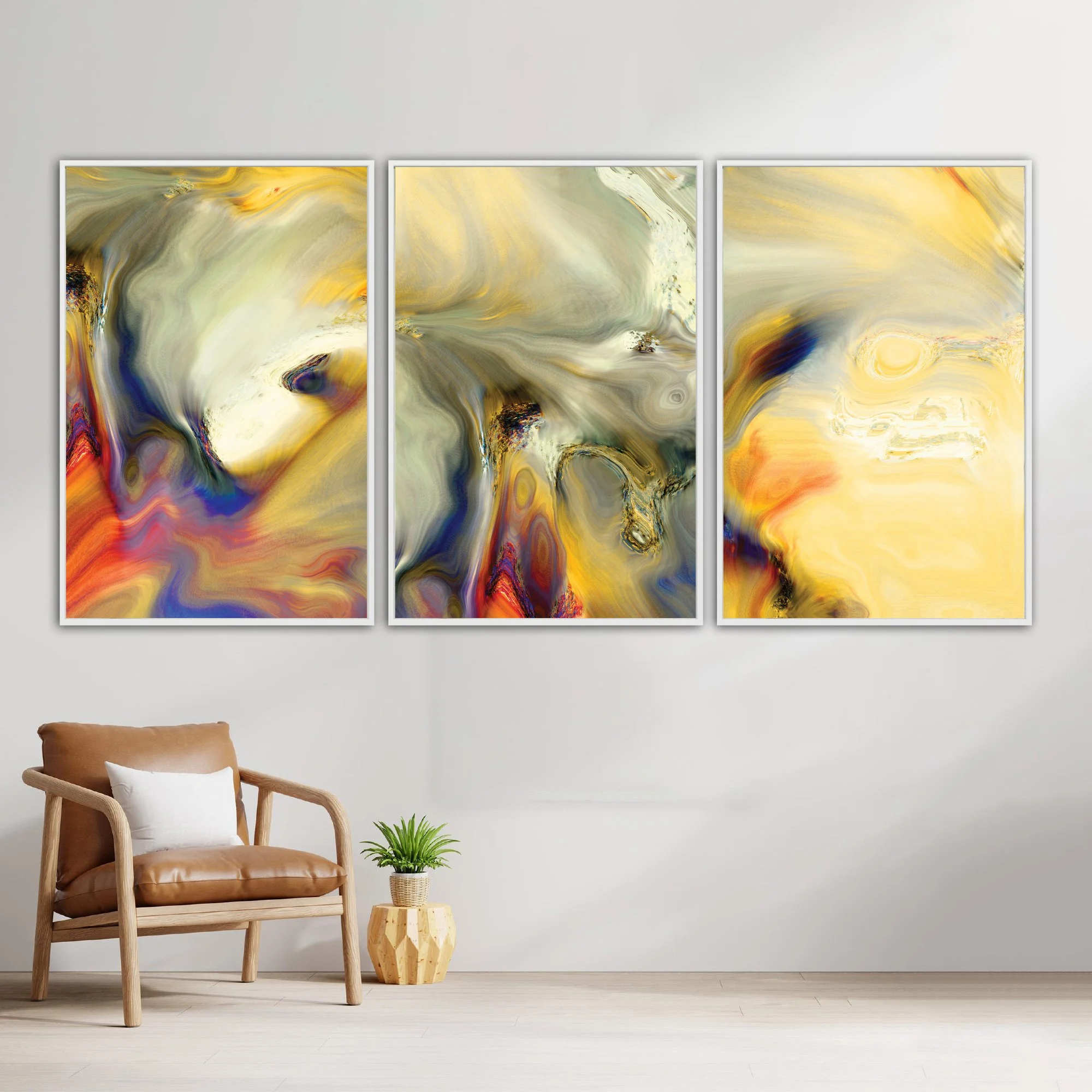Abstract triptych with liquid textures in warm gold, ocher, and cream, contrasting with deep navy blue and terracotta swirls, framed and ready to hang. With chair