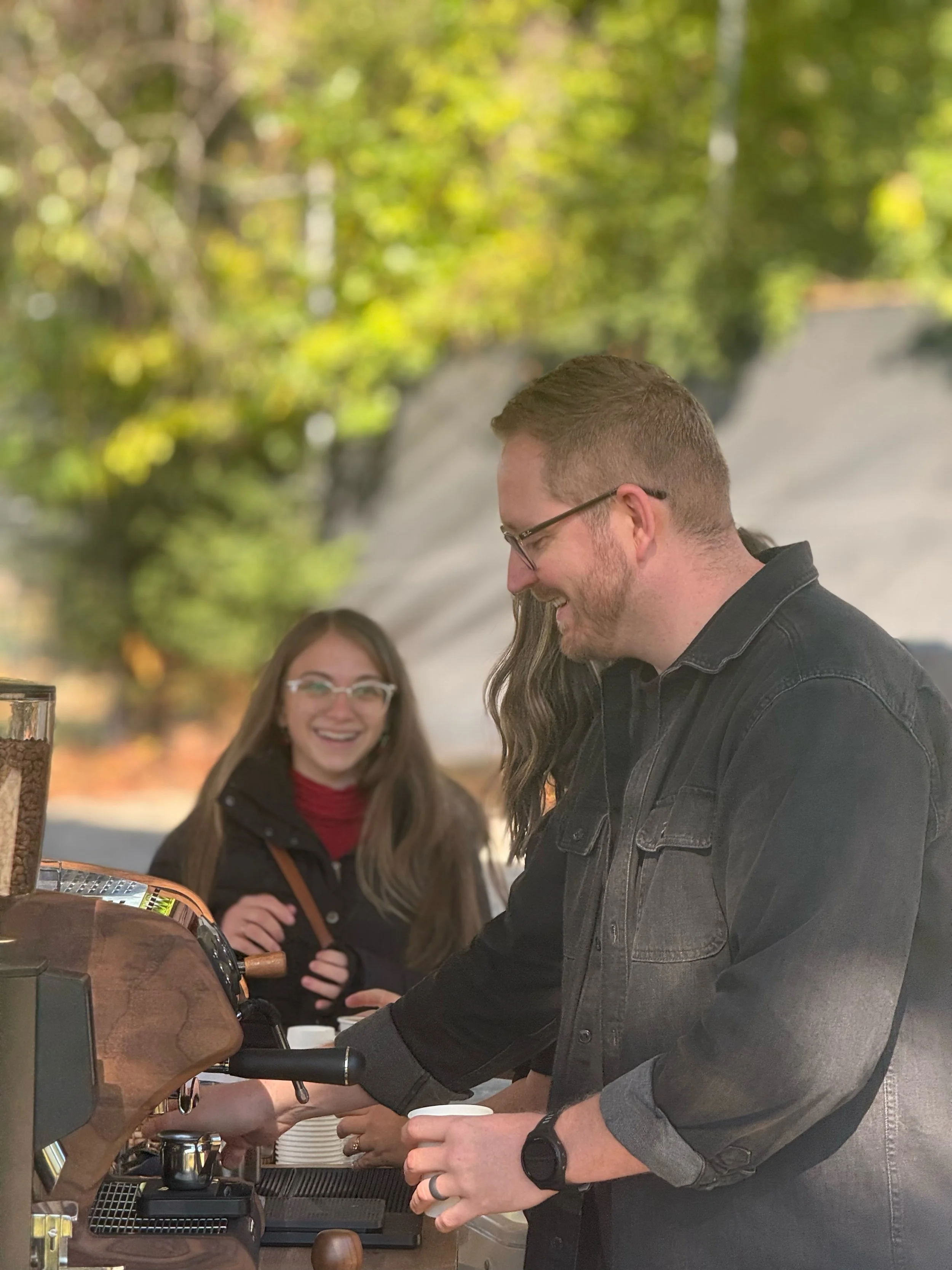 Barista serving a latte to a guest at a Bryant event