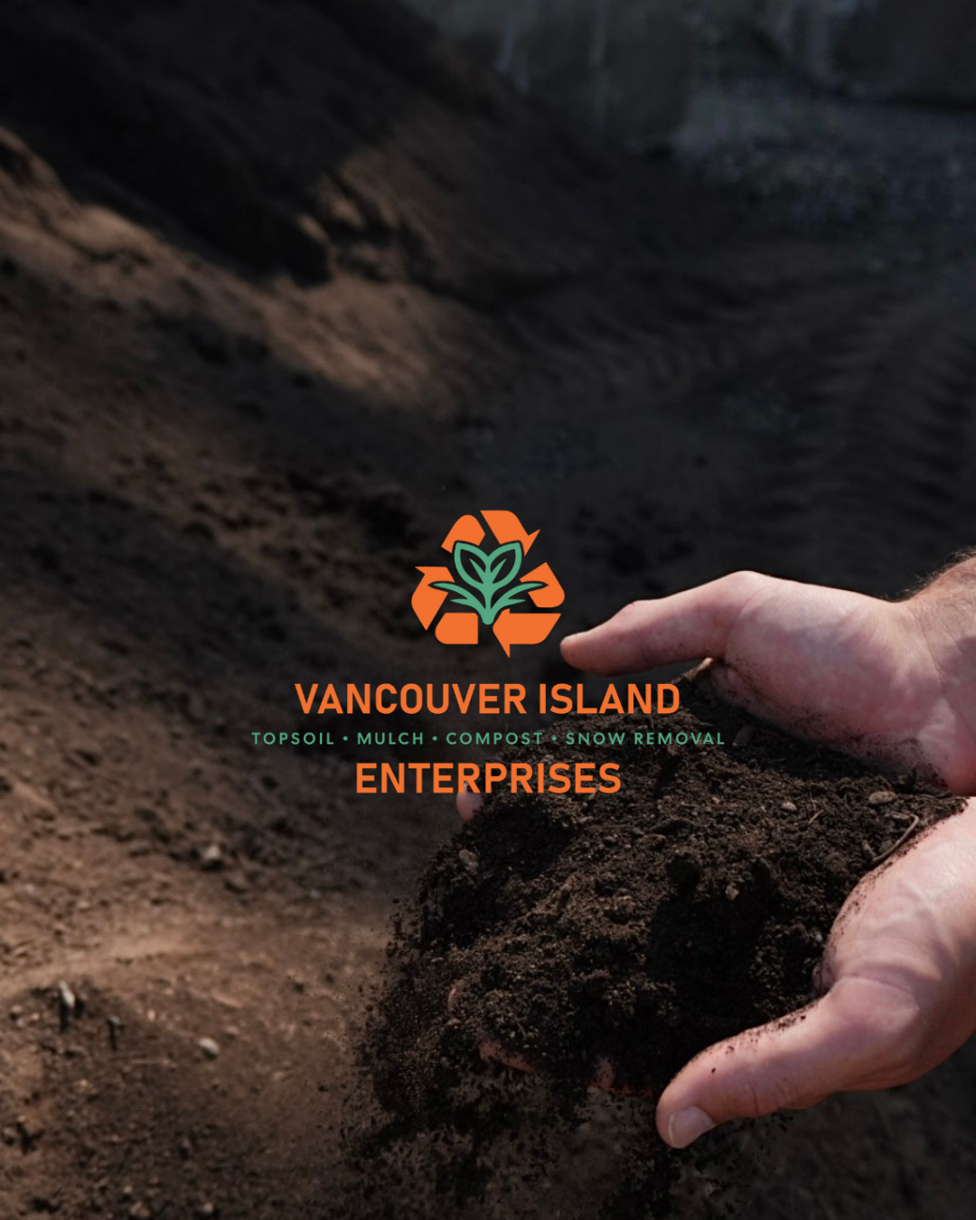 Hand scooping soil on a mound at Vancouver Island Enterprise's site with plant and recycling logo