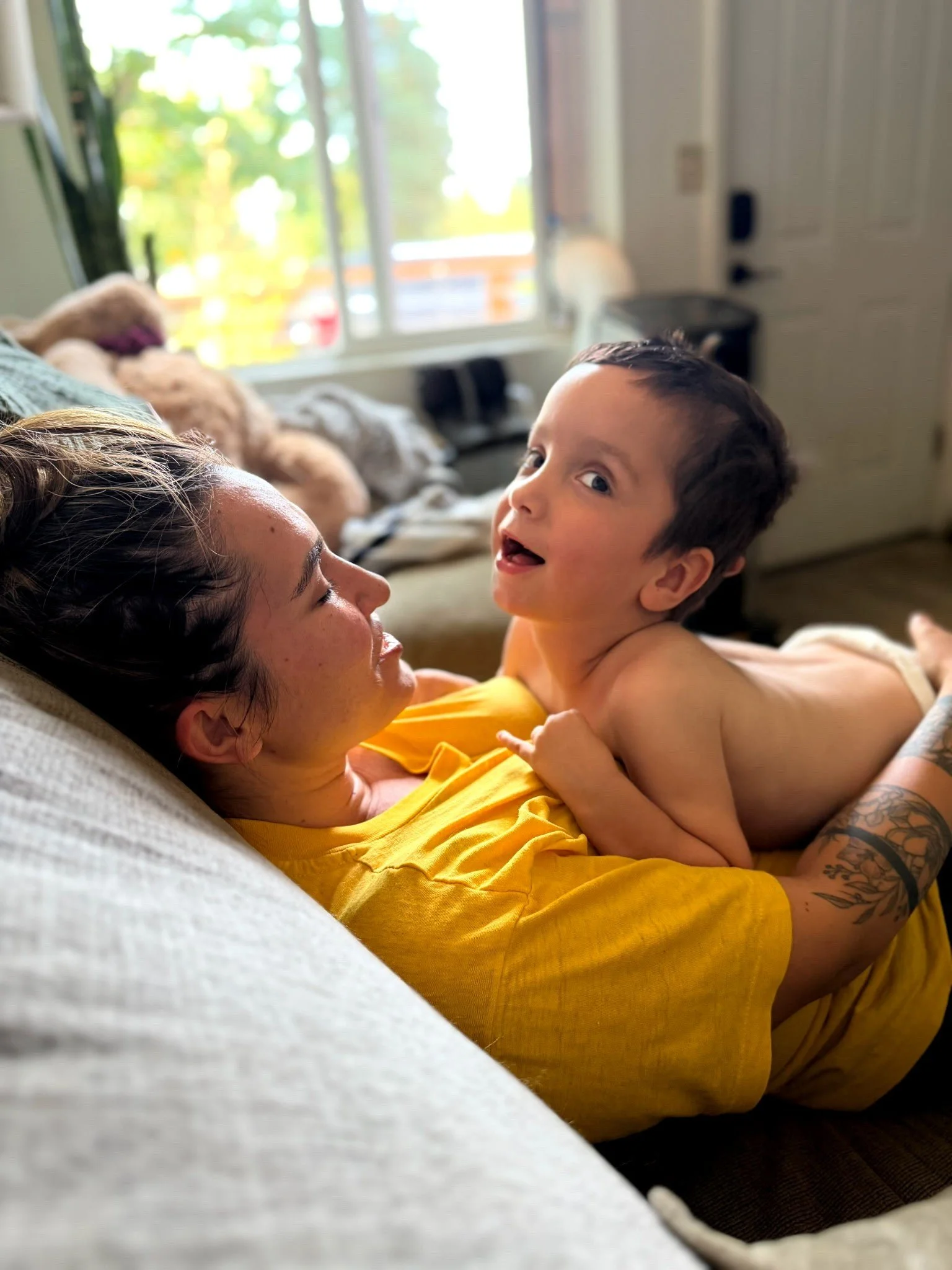 Silas smiling at Mama on the couch
