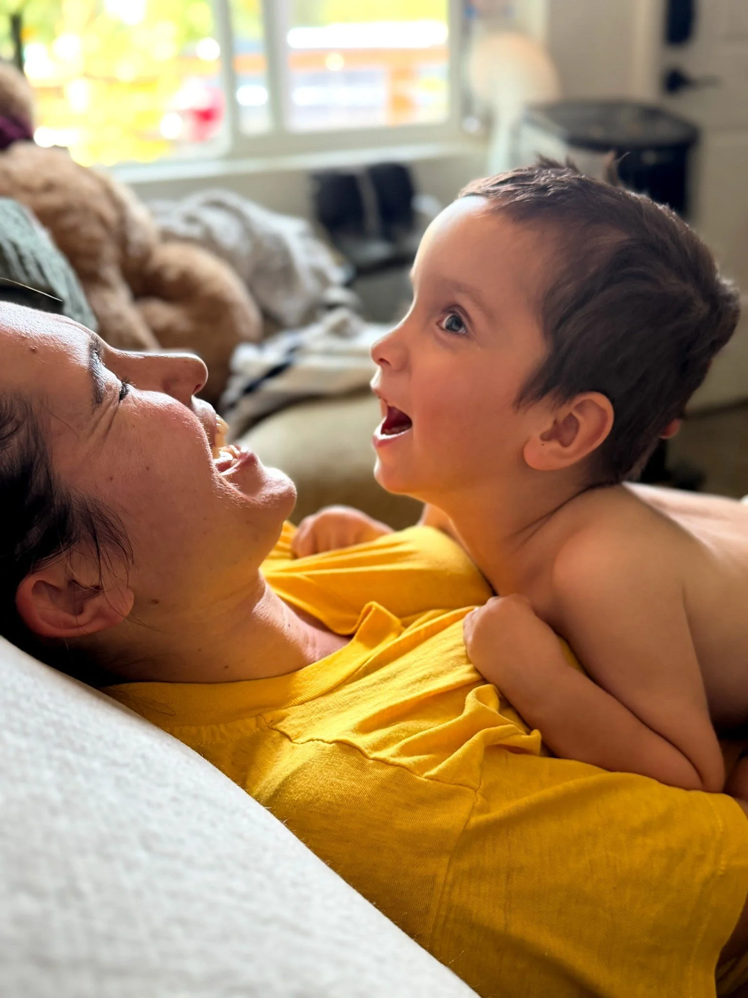 Silas smiling at Mama on the couch