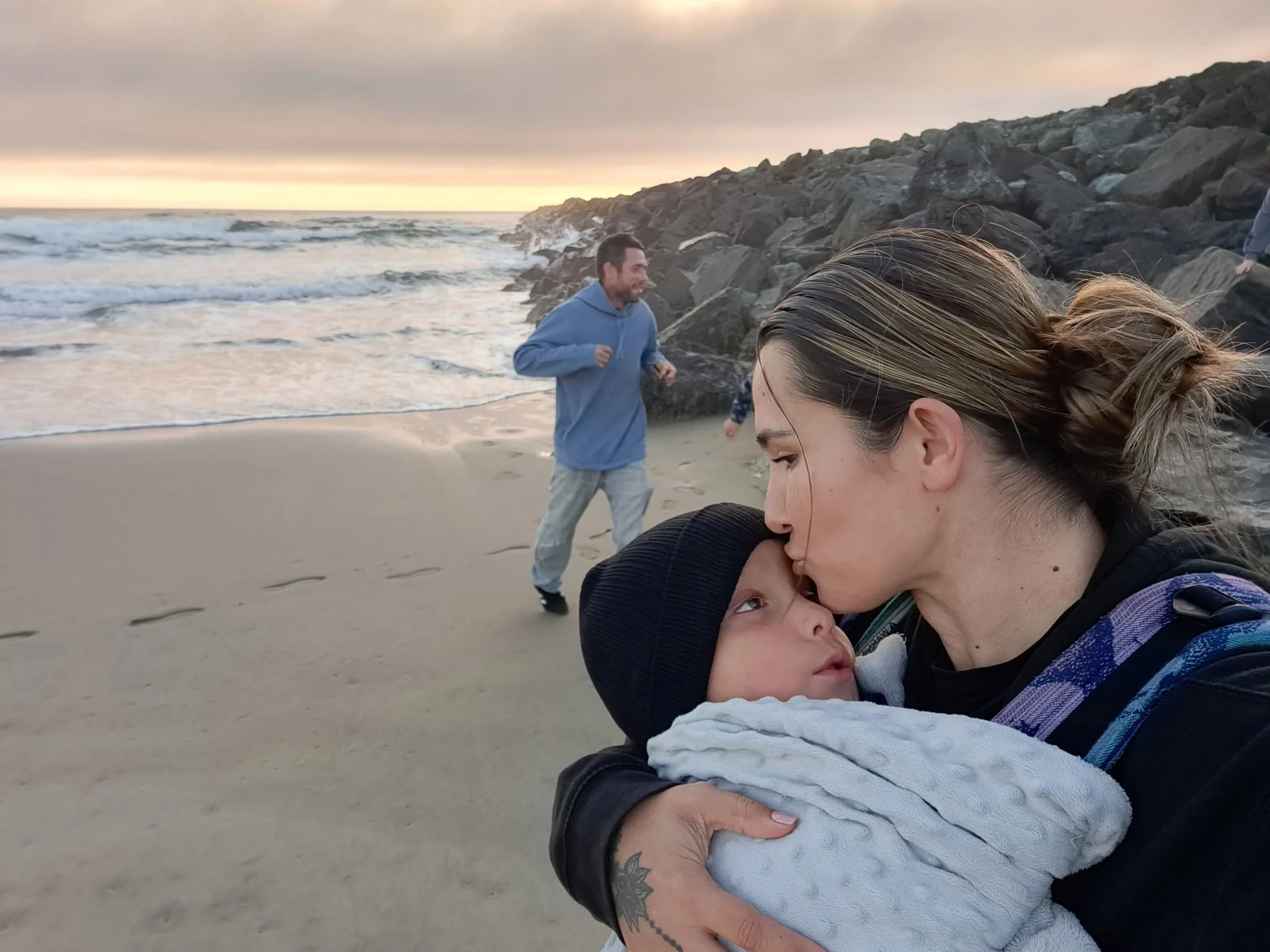 Mama kissing Silas on the beach