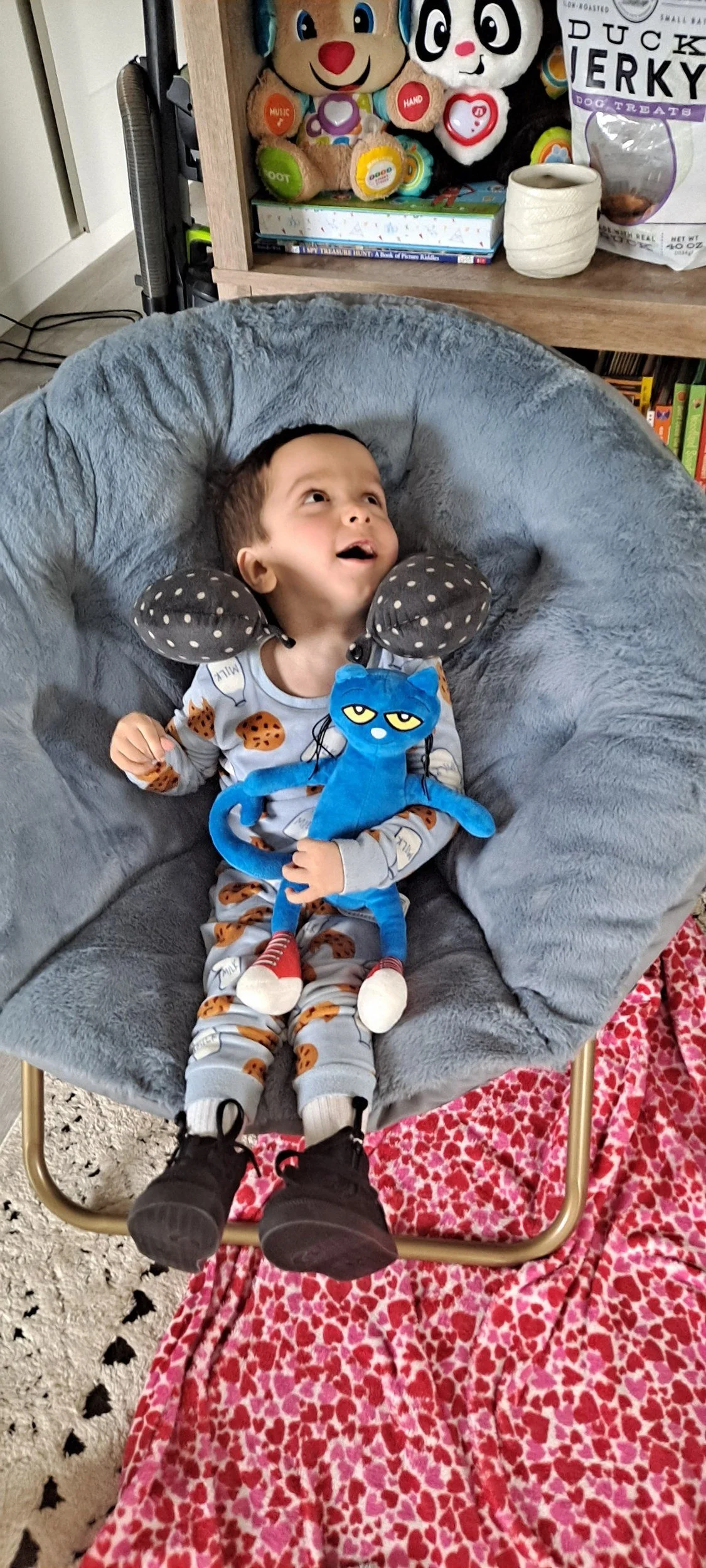 Silas smiling in his cozy chair