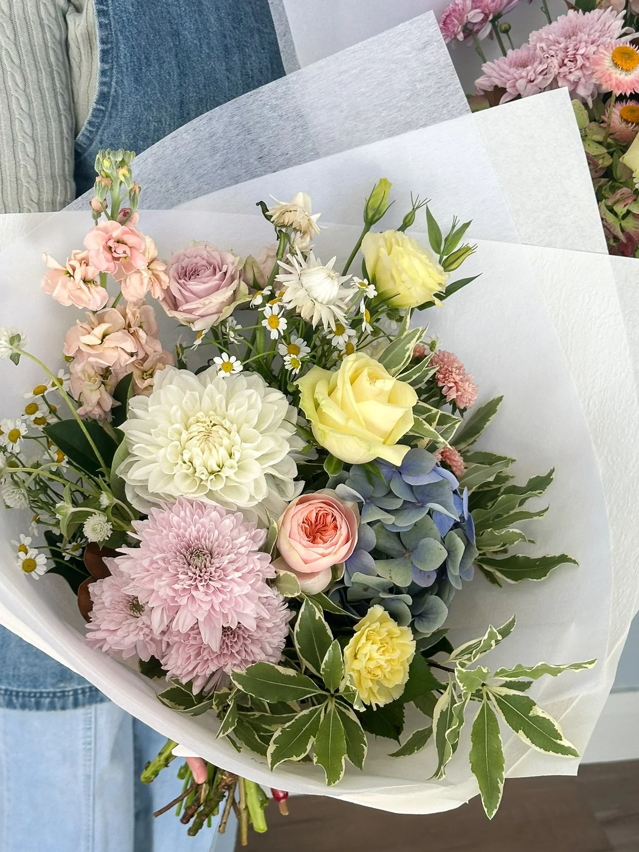 reverie-blooms-person-holding-blush-rose-lavender-mum.jpg