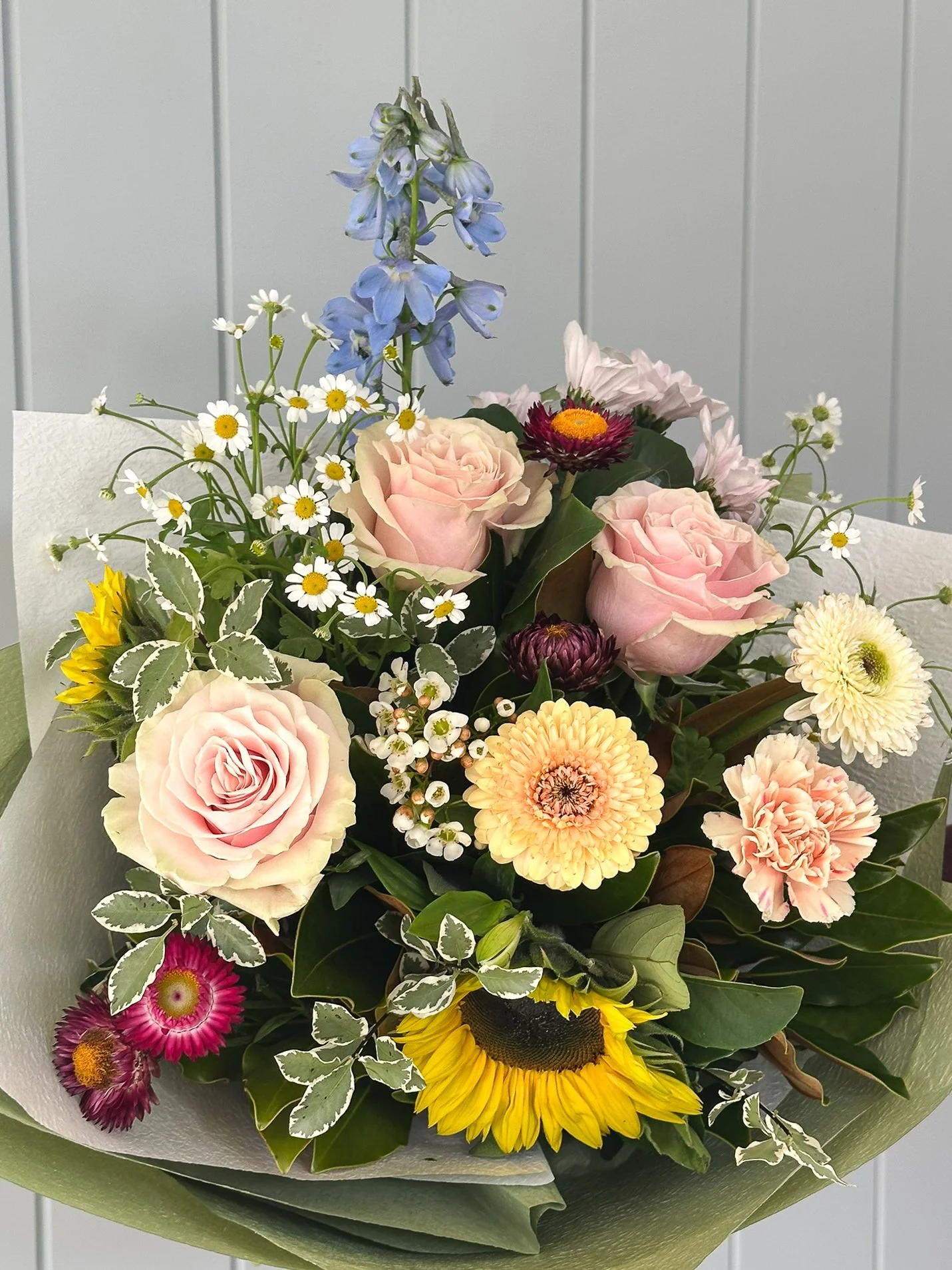 reverie-blooms-sunflower-delphinium-pink-rose-green-wrap.jpg