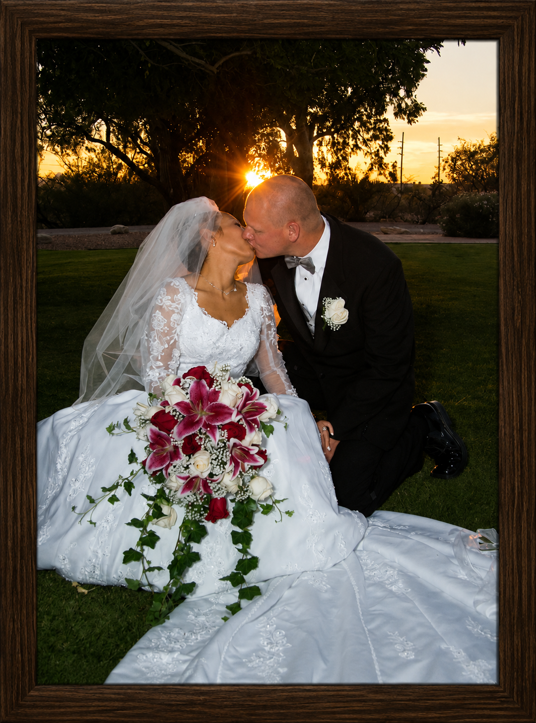 Sunset Wedding Kiss in a Wooden Frame.png