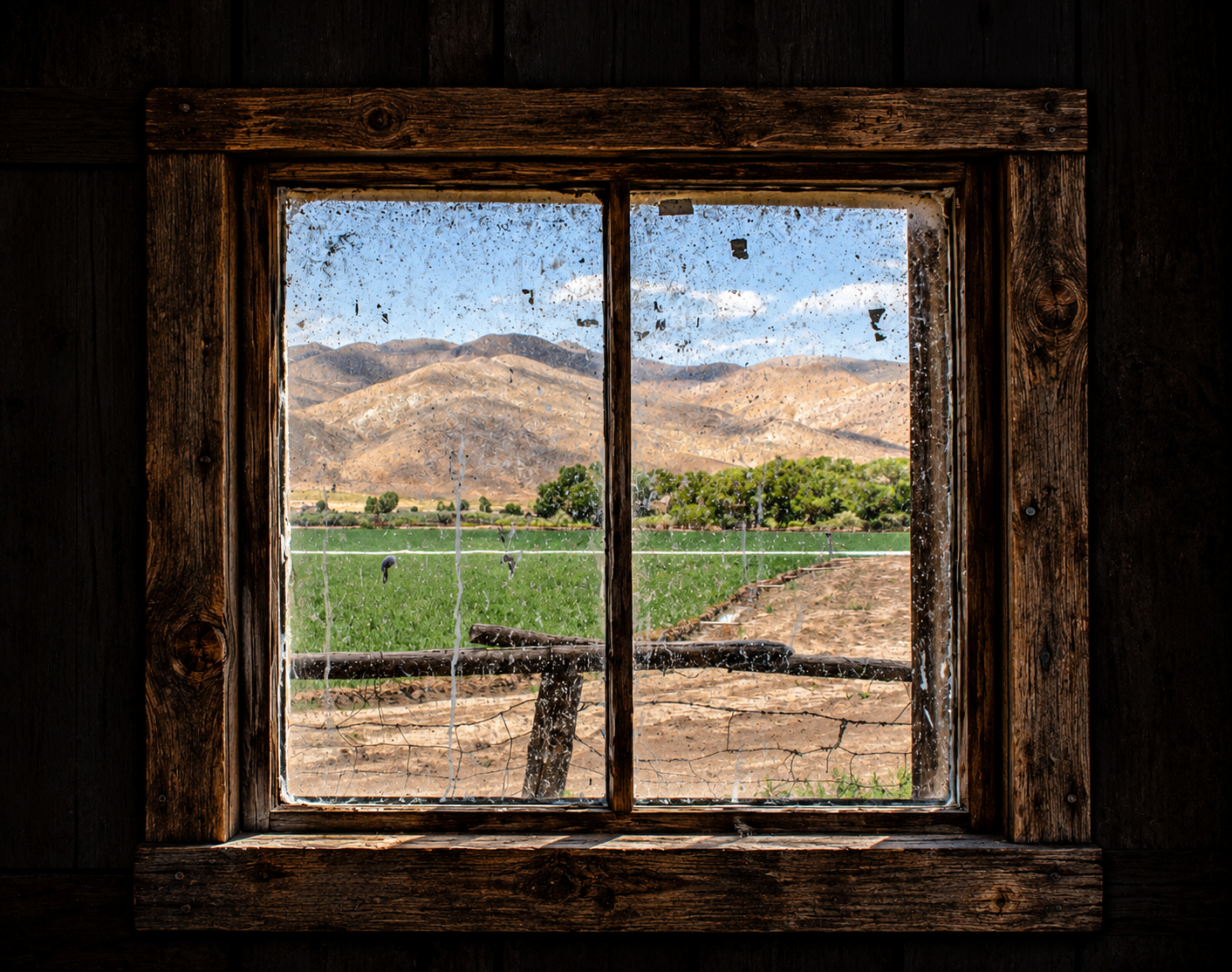 Rustic Barn Window Overlooking Countryside.png