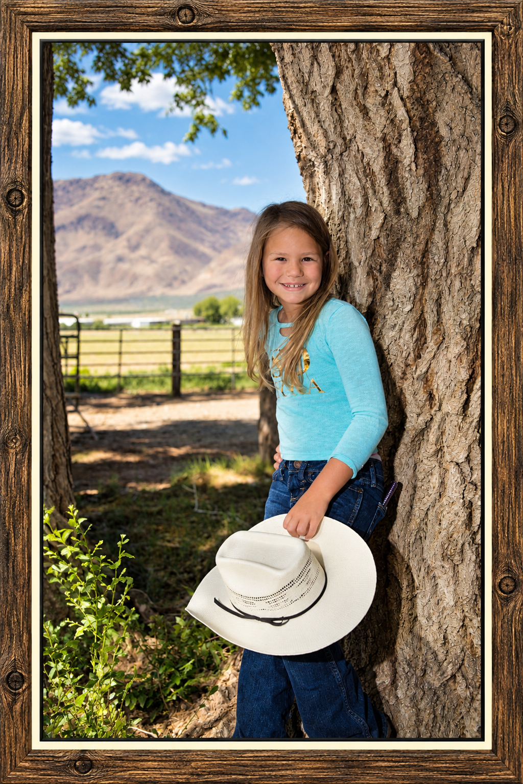 Framed Countryside Portrait with Cowboy Hat.png