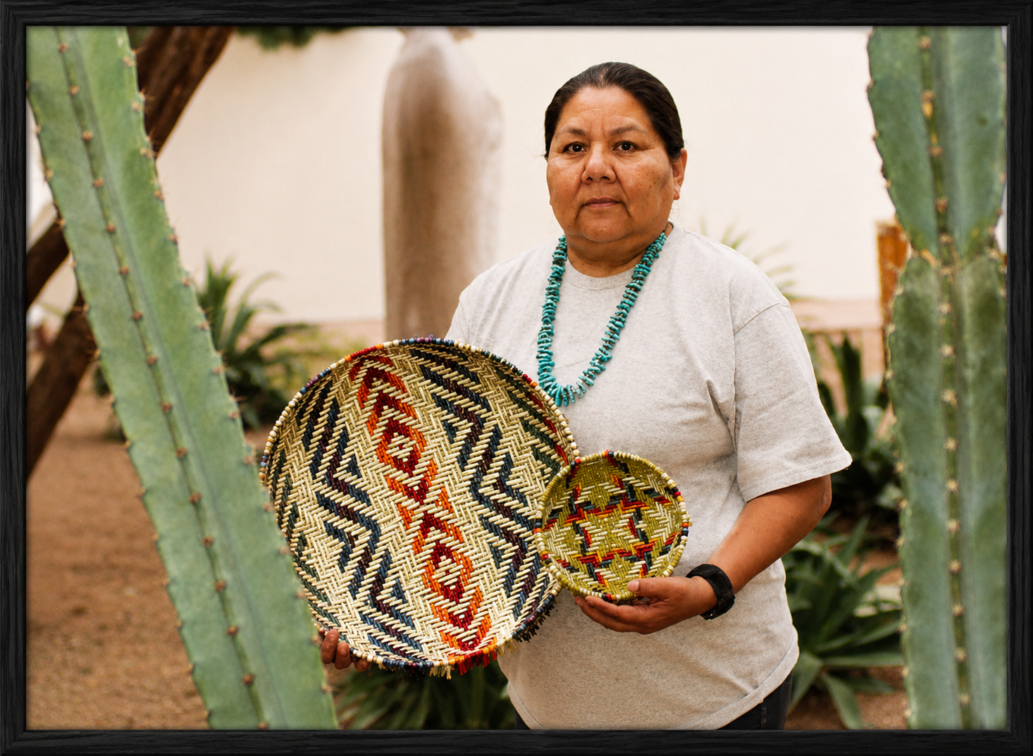 Indigenous artisan among desert cacti.png