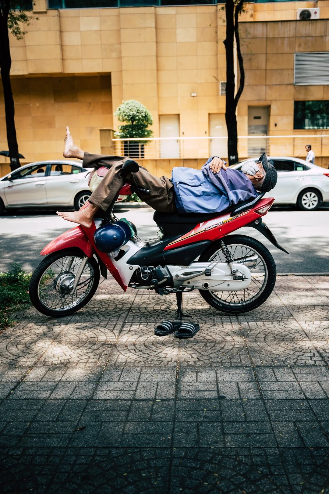 A man sleeping on his bike, Ho-Chi-Minh, Vietnam