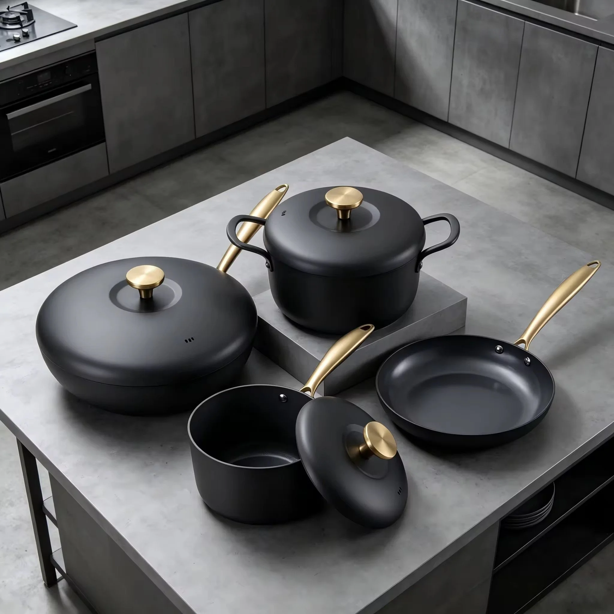 A modern kitchen with gray cabinets, gray countertops, and a gray floor. There is a stainless steel stove on the left and a metal table with black pots and golden handles in the center of the image.