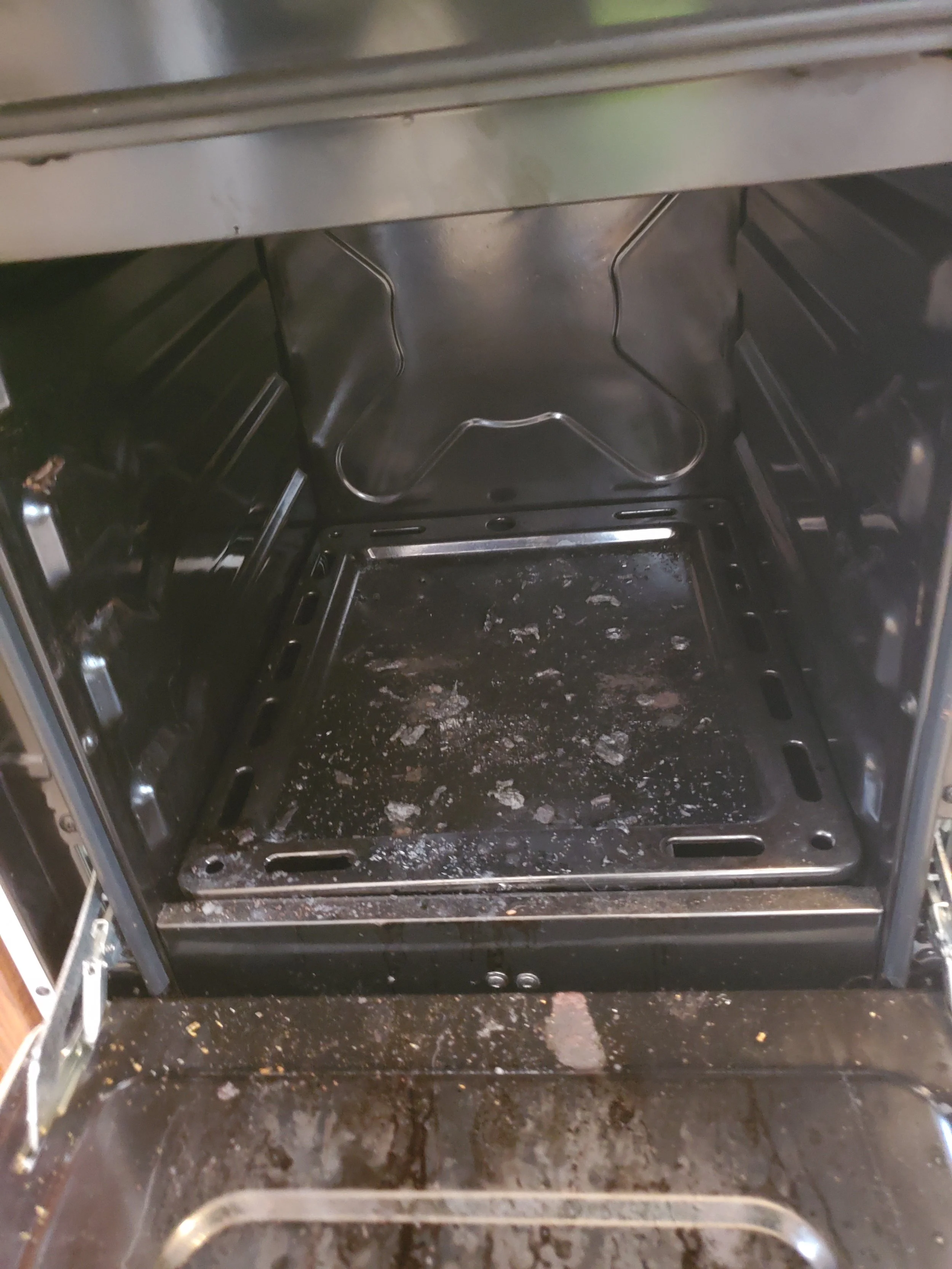 Oven interior with burnt food and debris -BEFORE DEEP CLEANING