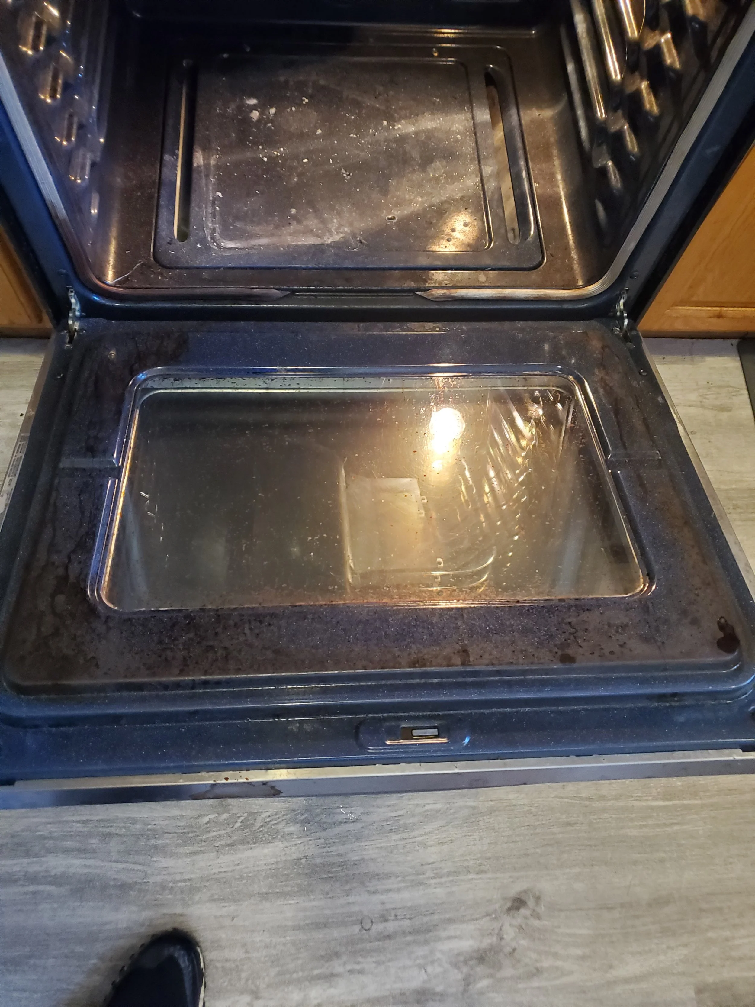 BURNT FOOD ON OVEN DOOR - BEFORE CLEANING