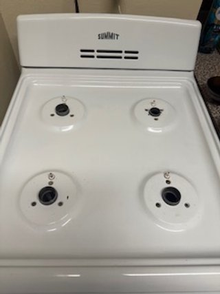 Empty white electric stovetop with four burners and a vent at the back labeled 'SUMMIT'.