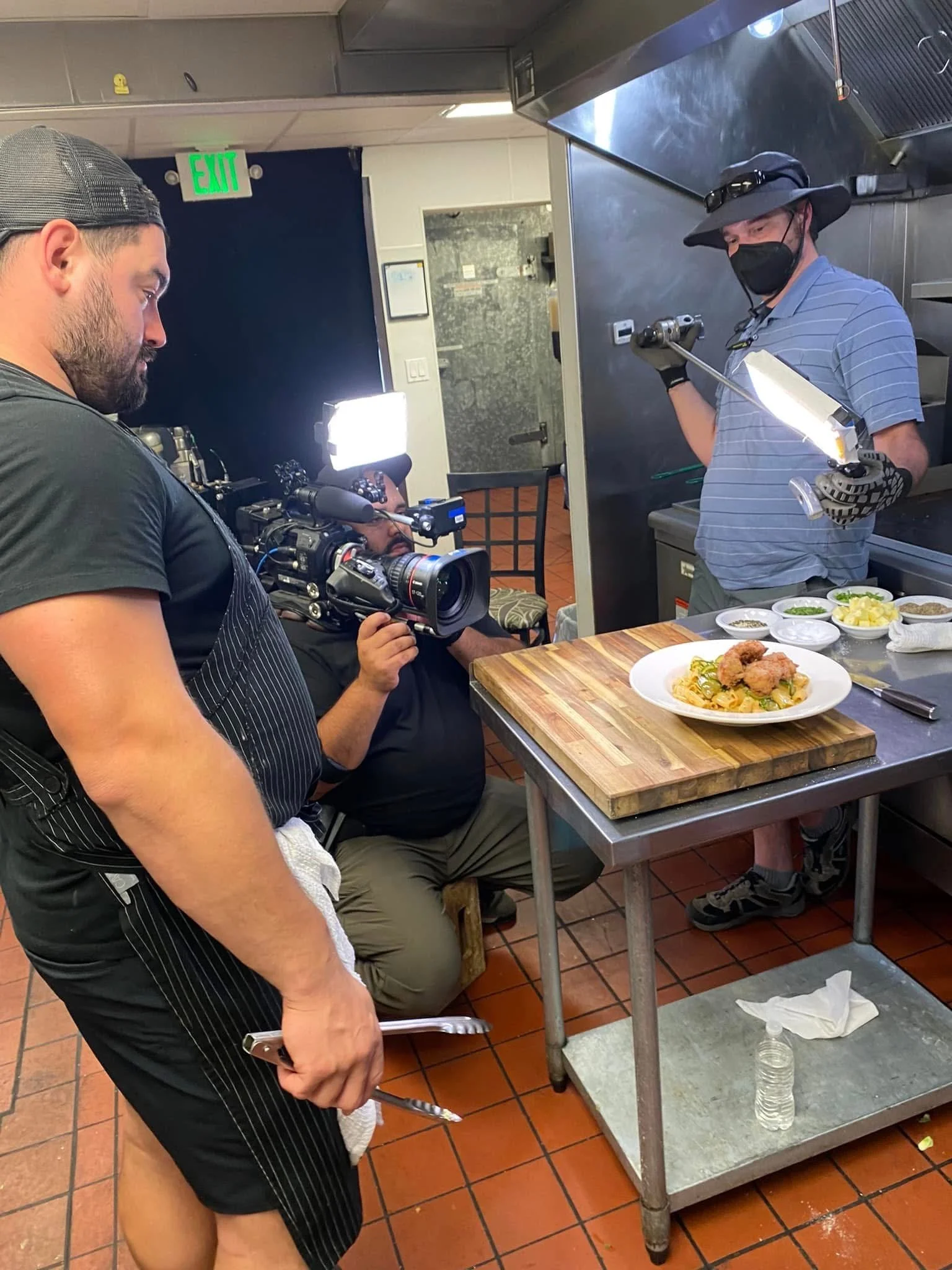 Seth Randal (R) helping grip lighting during shooting of a Food Network TV show.