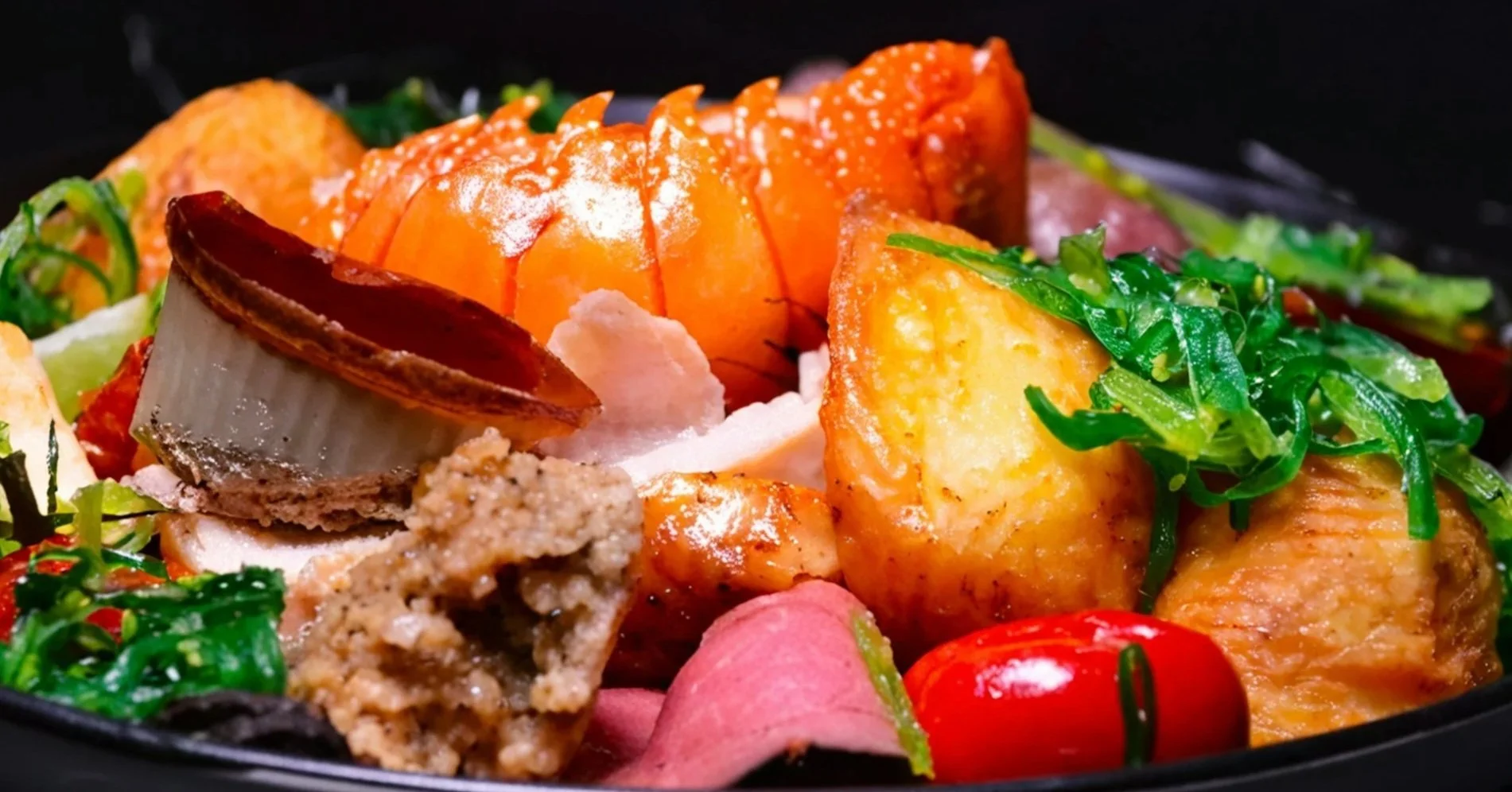 Seared hibachi lobster and scallops cooked fresh on a teppanyaki grill.