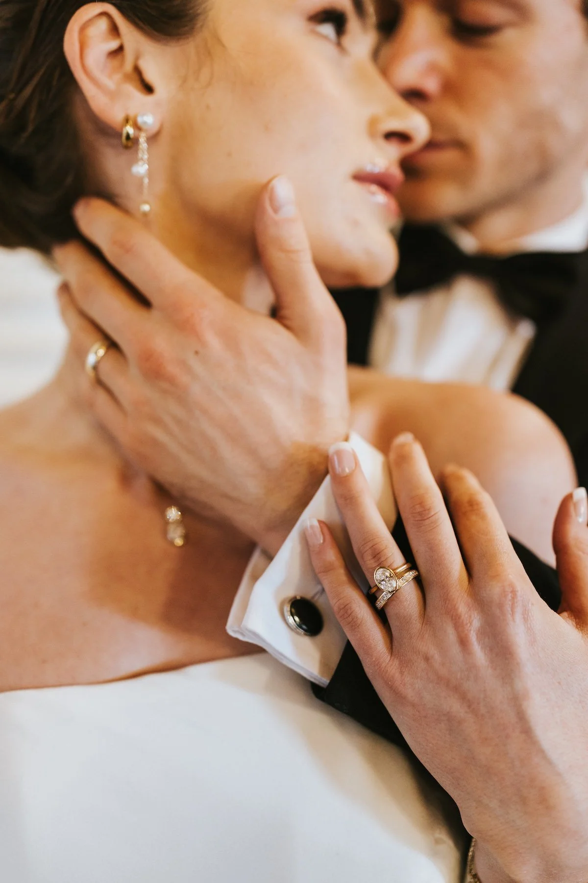 Close-up of a bride and groom sharing a tender moment during their wedding, with the groom gently holding the bride's face. Romantic Wedding Make-up