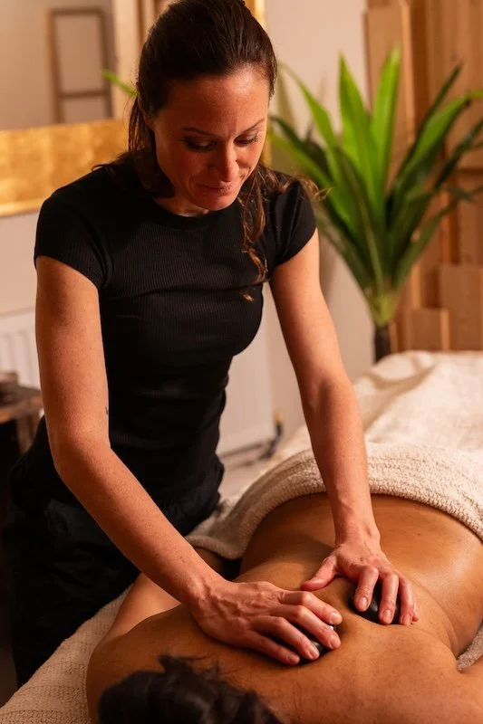 Virginie providing a therapeutic back massage treatment in Brighton to relieve muscular tension and promote relaxation.
