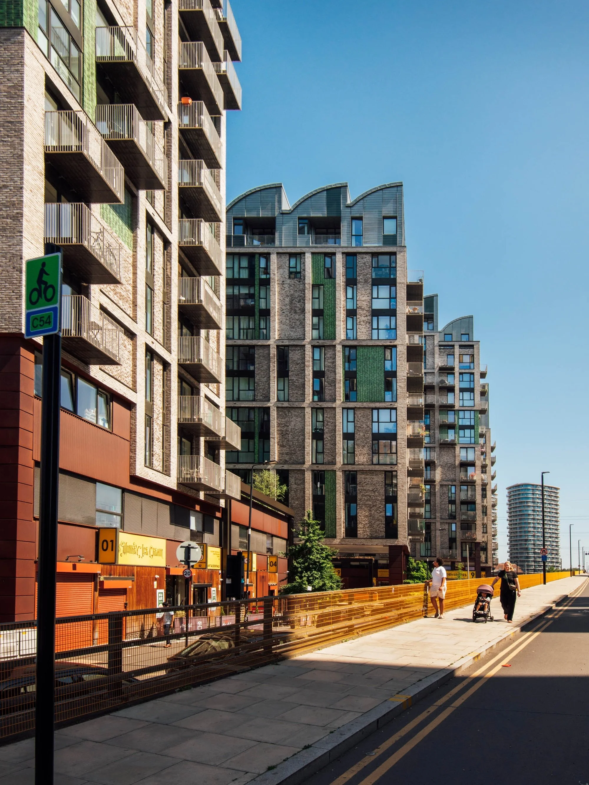 Photographing Canning Town&rsquo;s Caxton Works for @studioegretwest (during the summer heatwave!). Loved how the shadows and pools of light worked out here, and how the guy in white&rsquo;s creating a strong eye-line towards the towers. He was just 