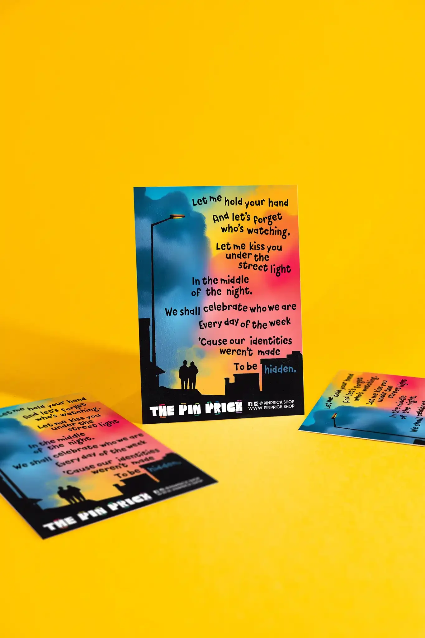 Colorful flyer with sunset background, featuring two people holding hands and a street lamp, with text promoting celebration of identity.