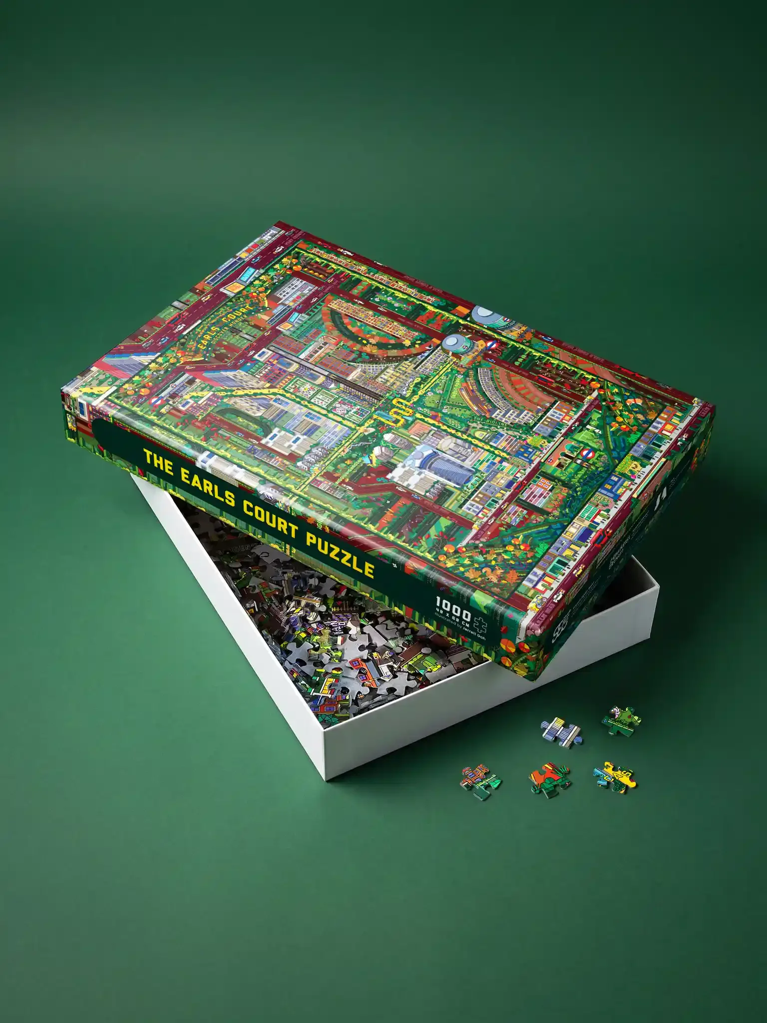 A box of The Earls Court Puzzle partially opened on a green surface, with several puzzle pieces scattered outside the box.
