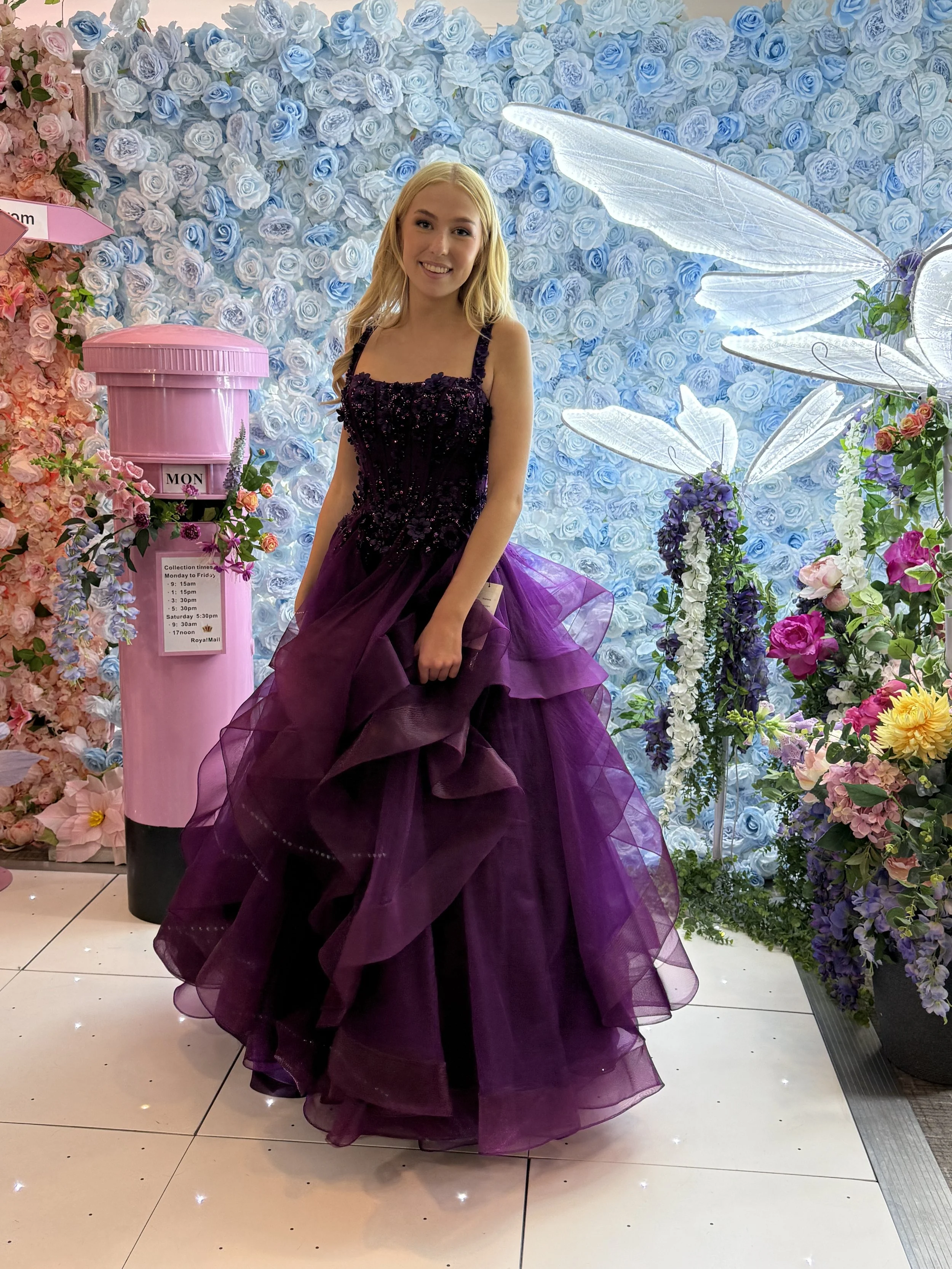 Girl in deep purple sequin corset prom ball gown with layered tulle skirt