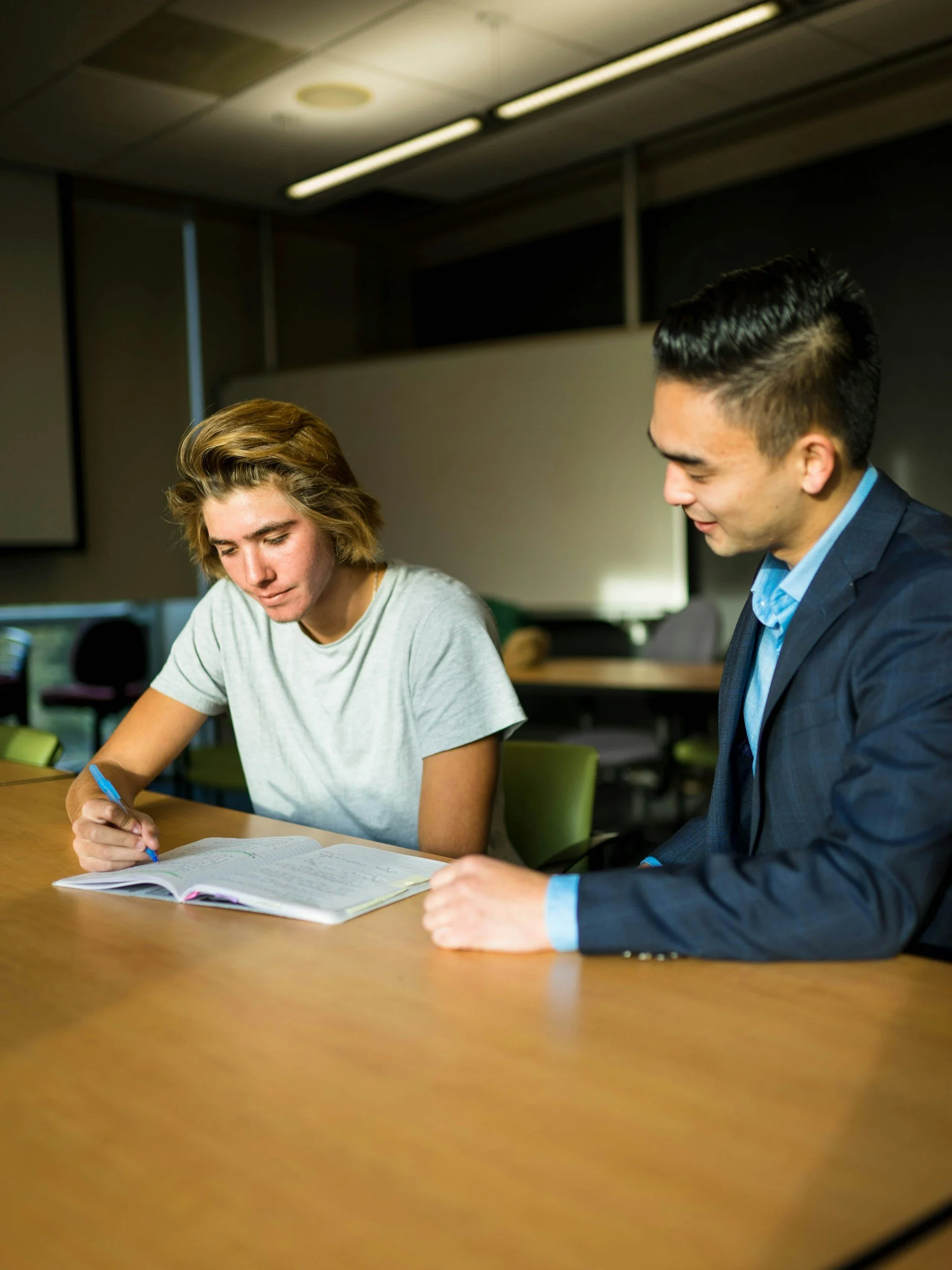 A student working with an adult mentor on an academic planning task.