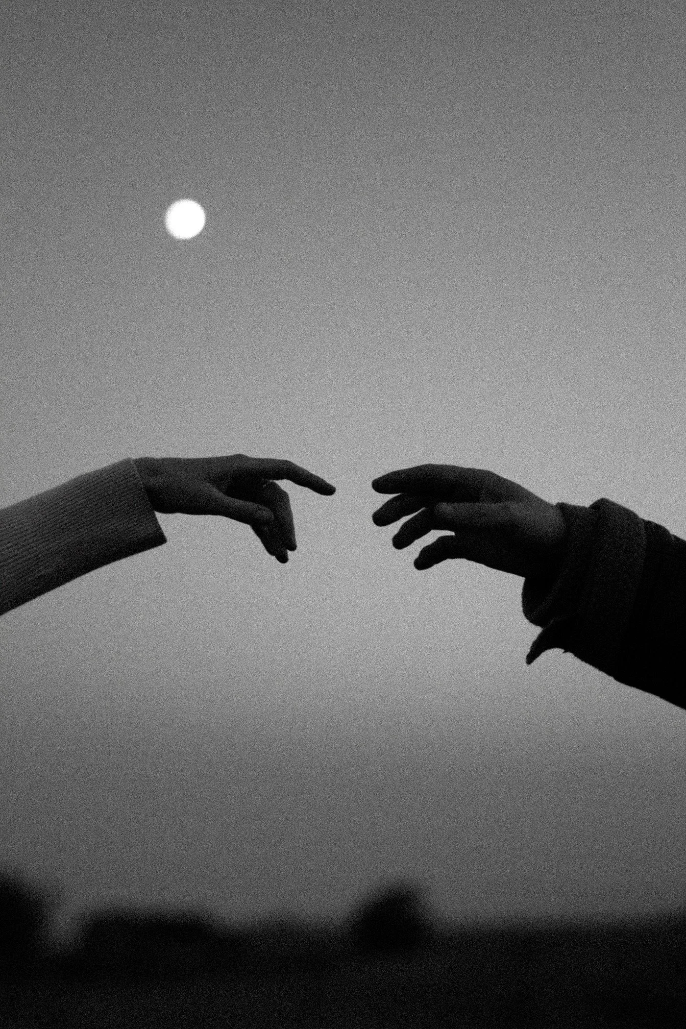 Two hands reaching for each other, the heart of EFT couples therapy.