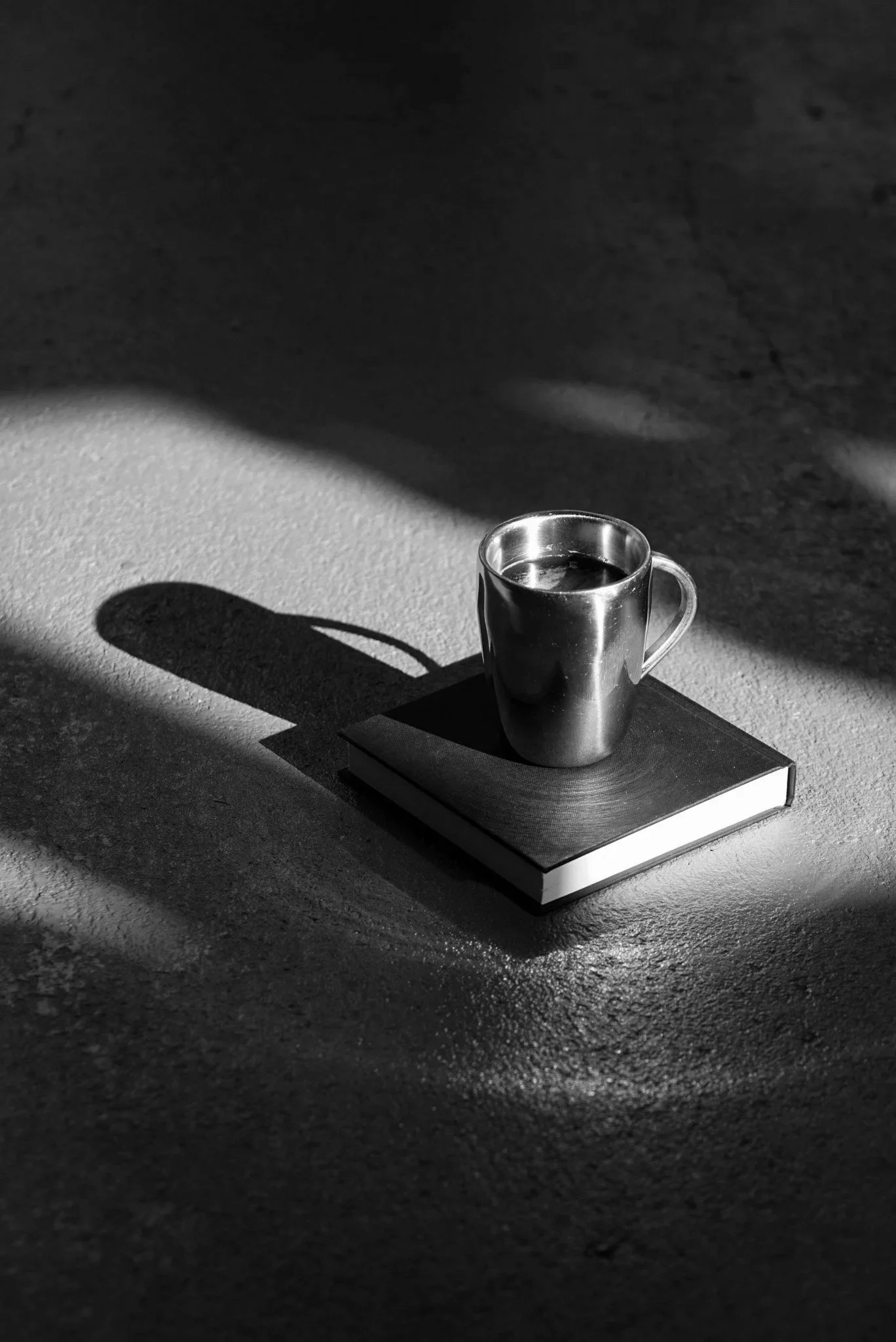 A coffee cup resting on a book, from Love Between the Lines, a serialised novel about love.