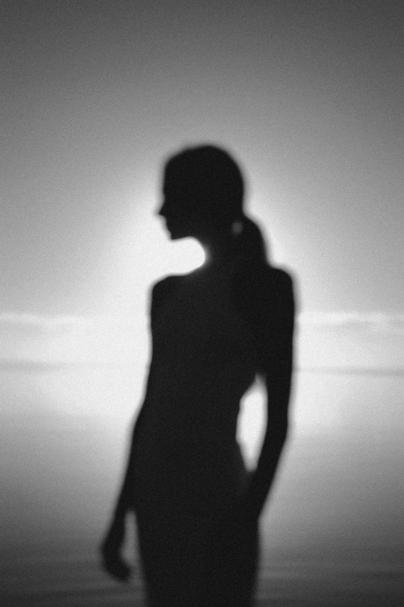 A woman looking out at the ocean, reflecting on where her relationship is heading.